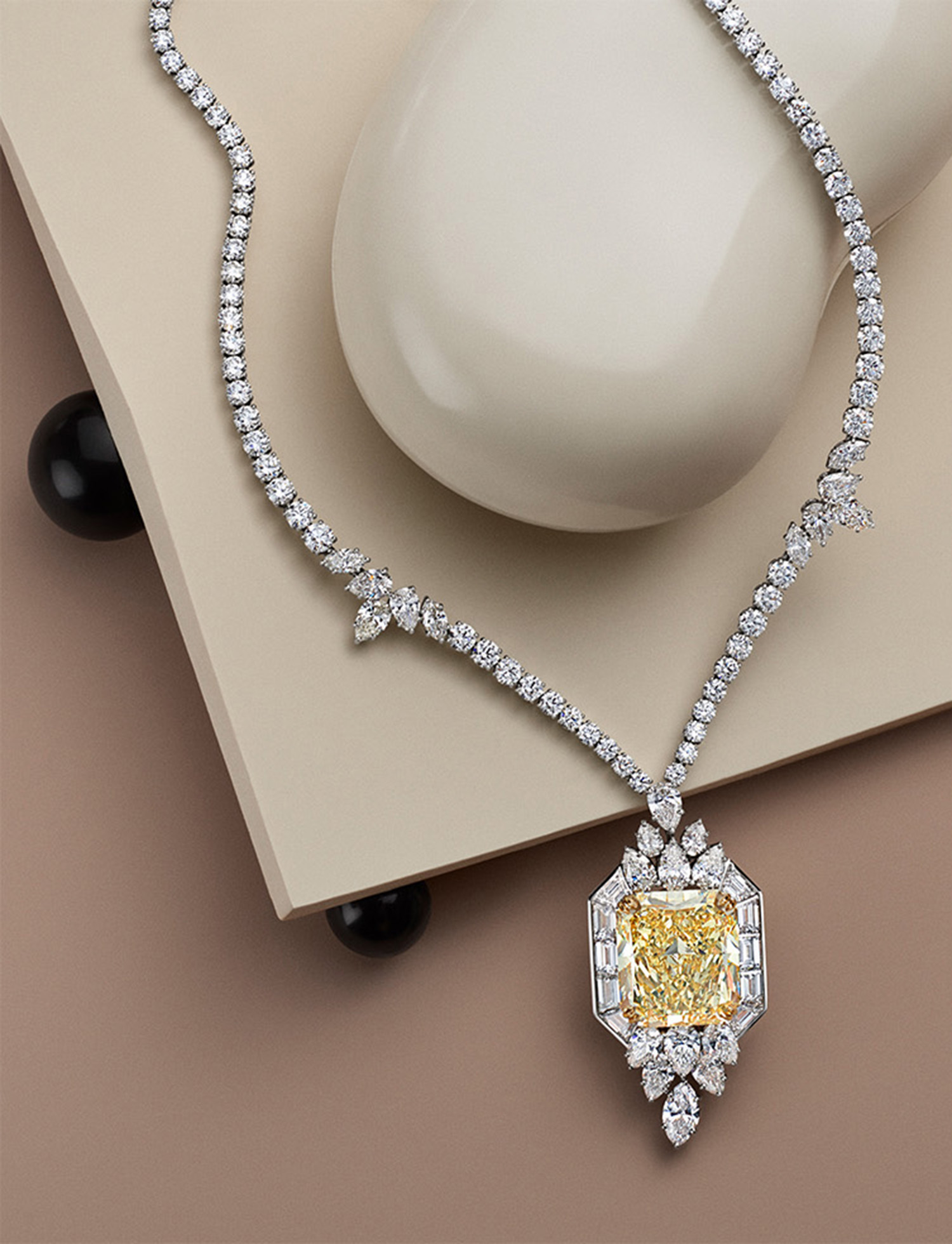 KMA stylist Sara Wacksman designs set for photo of glittery diamond necklace with a light yellow gemstone for Vogue Hong Kong