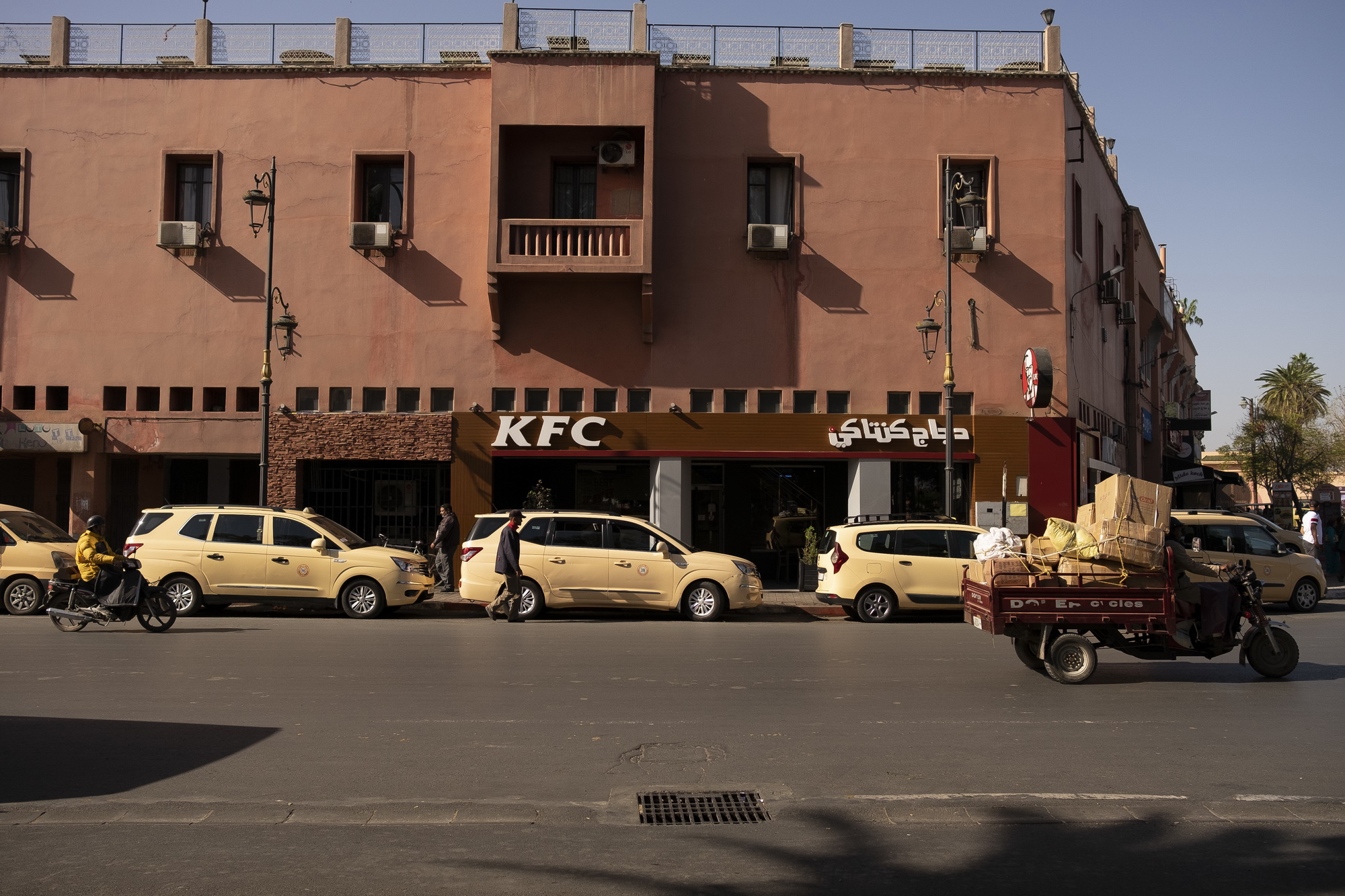 Sandy colored taxies and KFC near frequent tourist spots.