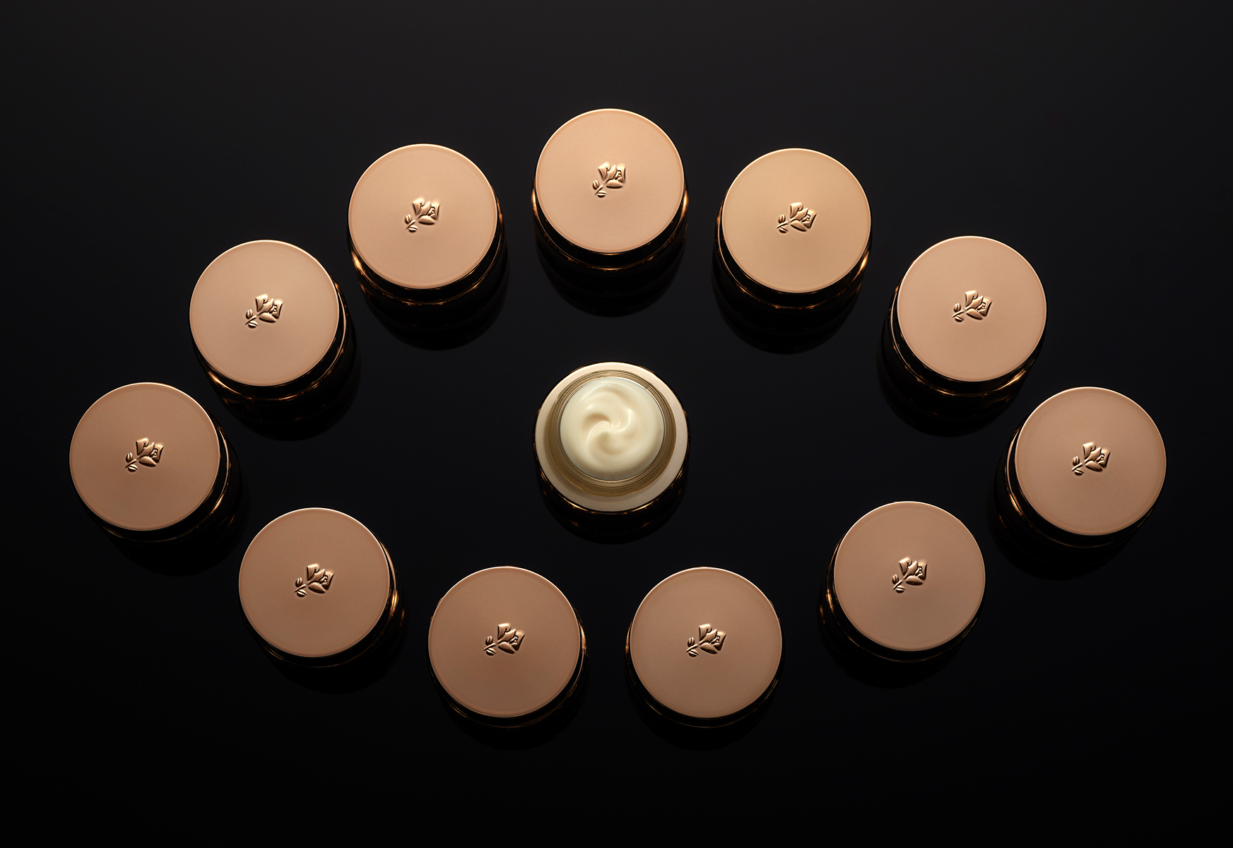 KMA photographer Isabelle Bonjean shoots photo of several Lancome eye cream bottles revealing the texture of the eye cream