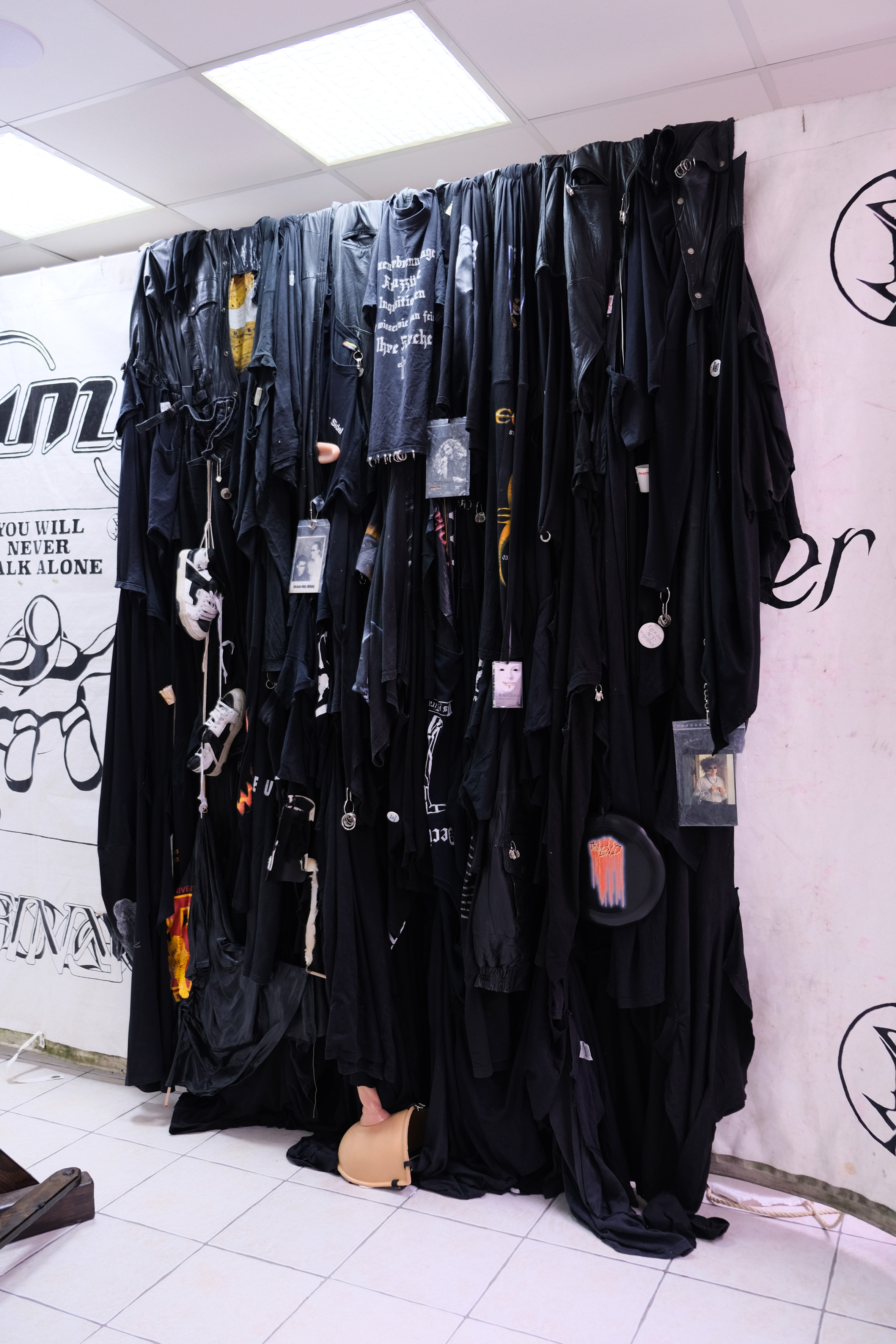 YWNWA final curtain detail, 2021. T-shirts, tarpaulin, various objects, 230 cm x 400 cm.