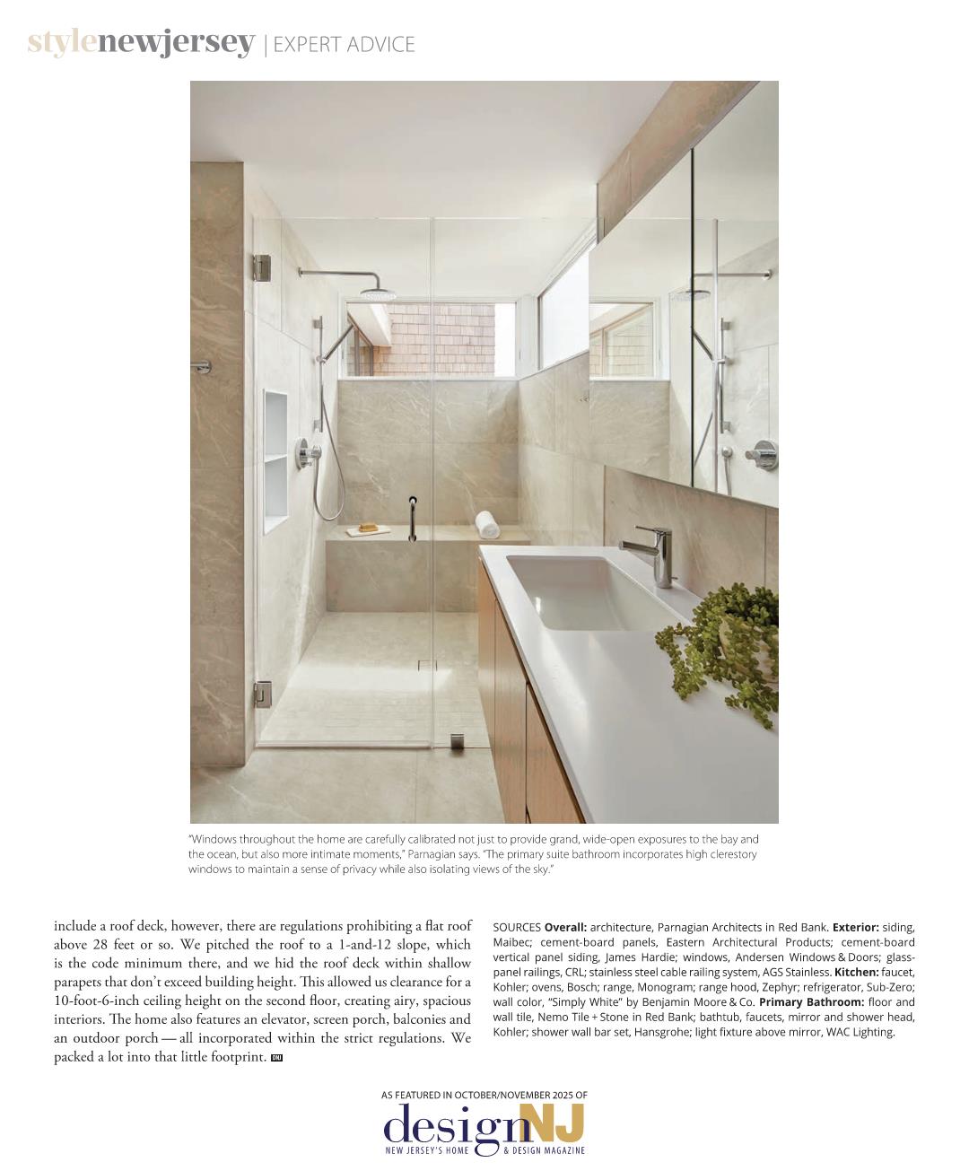 Interior photograph of The Gap House modern shower, featuring seamless glass enclosure, rain shower head, built-in bench, and light-toned stone tile, as presented in Design NJ Magazine.