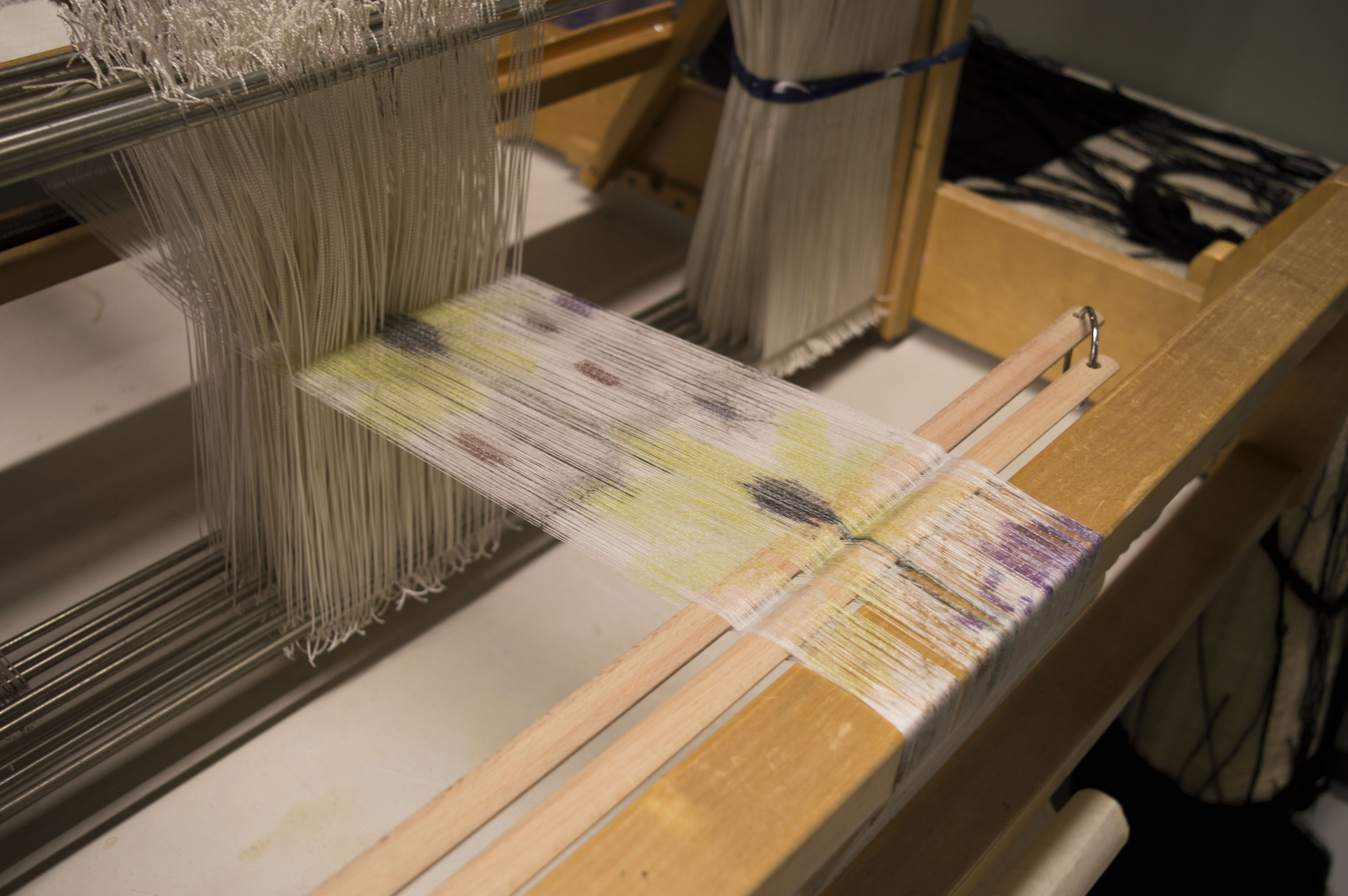 Process. Warp printed with sublimation inks on a table loom.