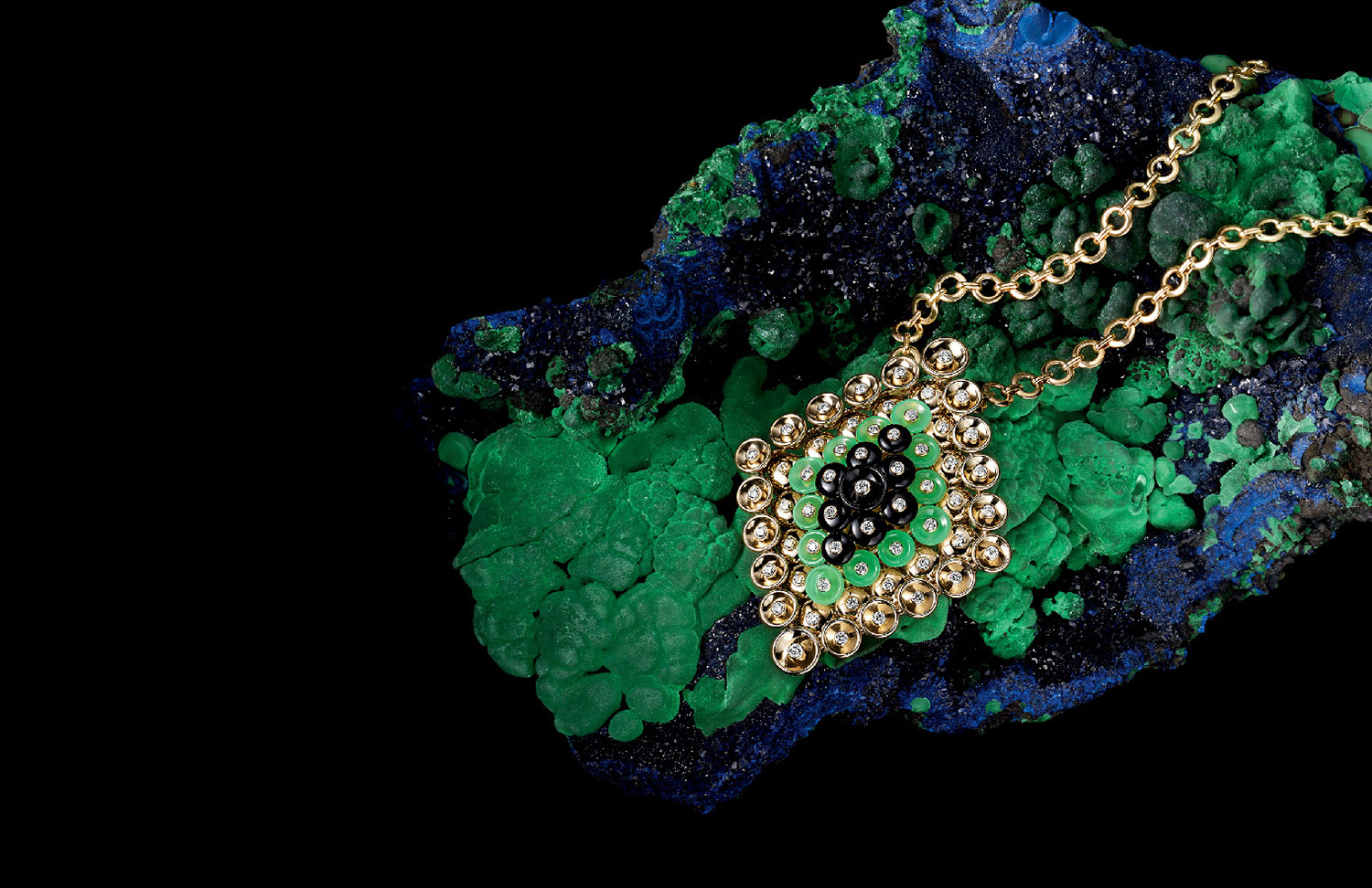 KMA stylist Sara Wacksman designs set for a photo of a gold necklace with blue and green background for South Coast Plaza
