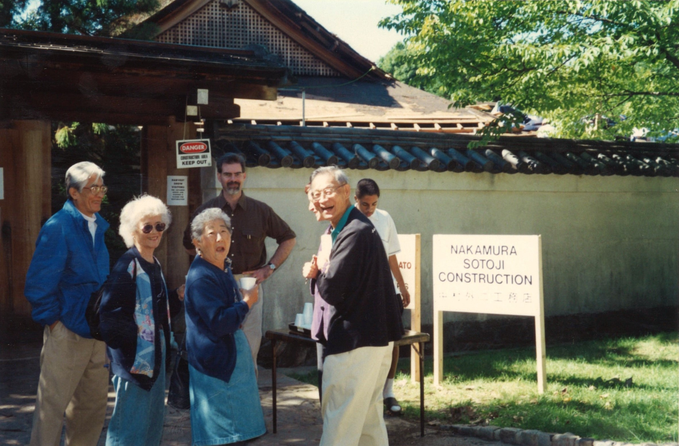 Supporters, including Grayce and Hiroshi Uyehara, gather in front of Shofuso as the restoration of the hinoki bark roof is underway, 1999