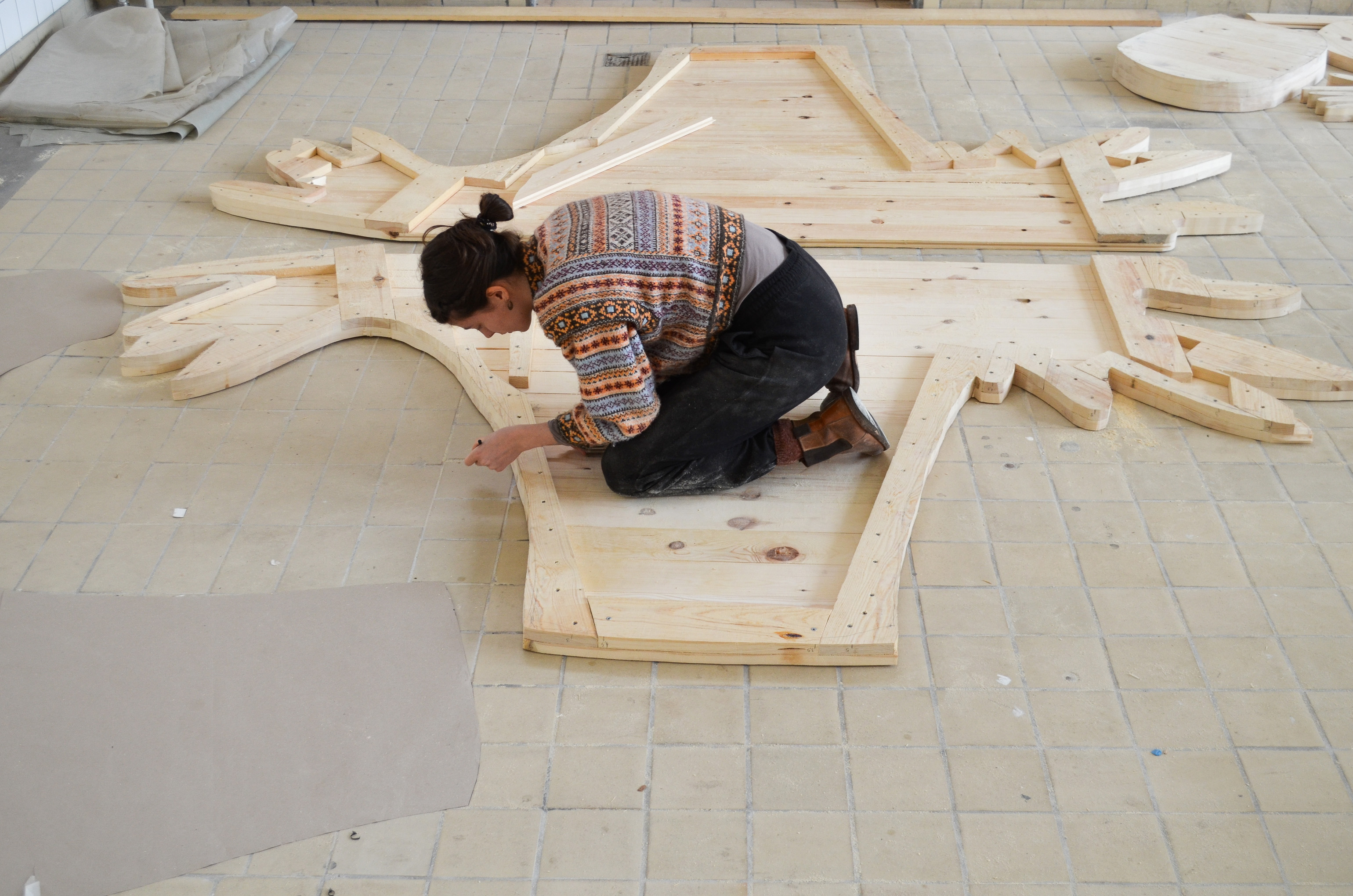 Process of hand building the sculpture in natural wood