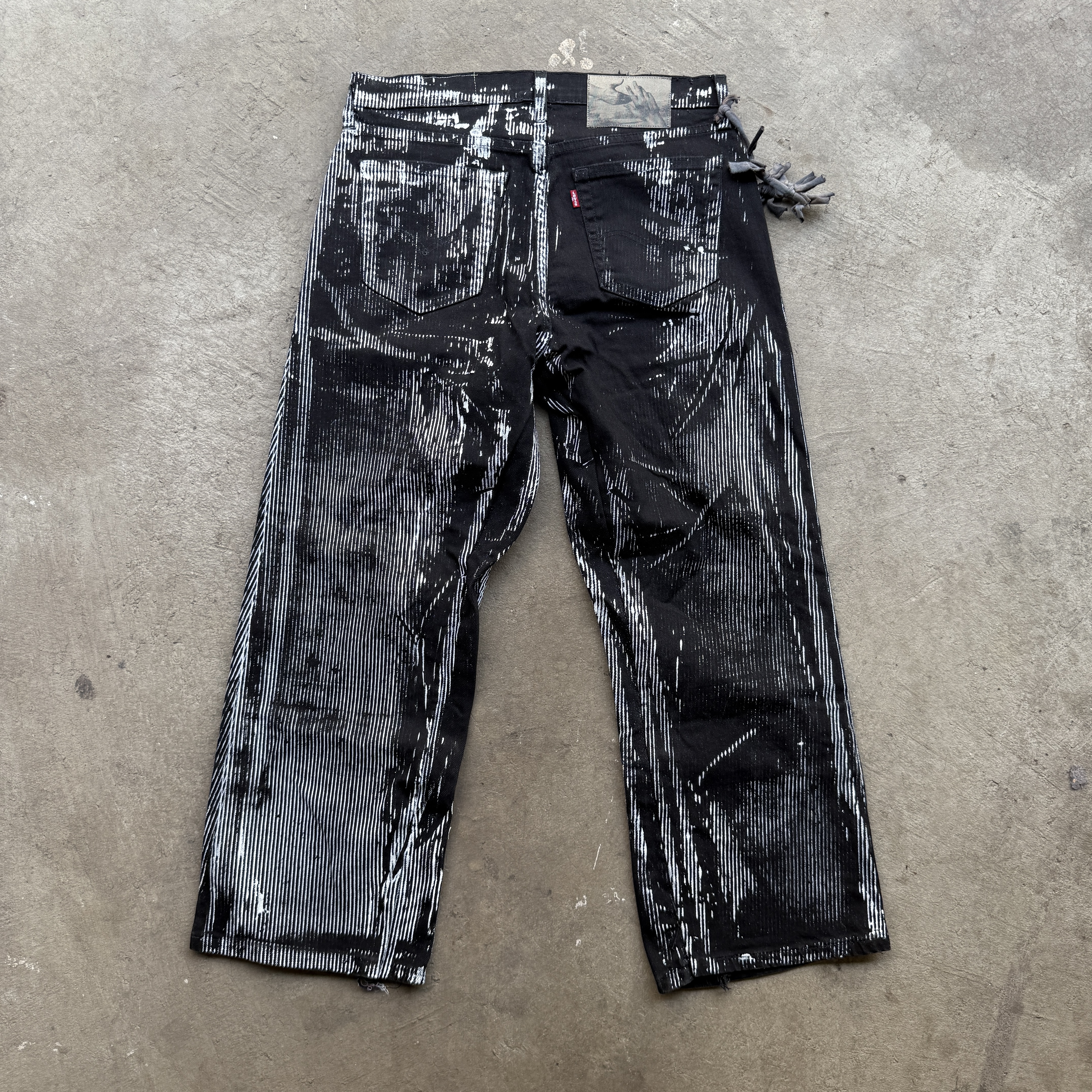 reclaimed vintage surplus denim screen printed with pinstripes in textile dye. tailored for straight/wide fit. fitted with custom keychain, scrap chain, and leather patches