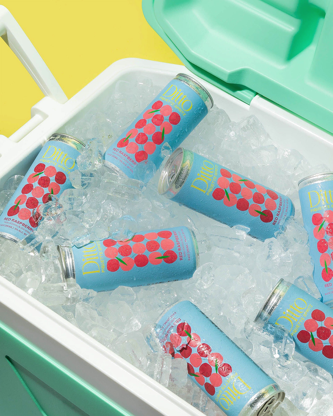 Cooler filled with ice and cans of Ditto piquette spritz