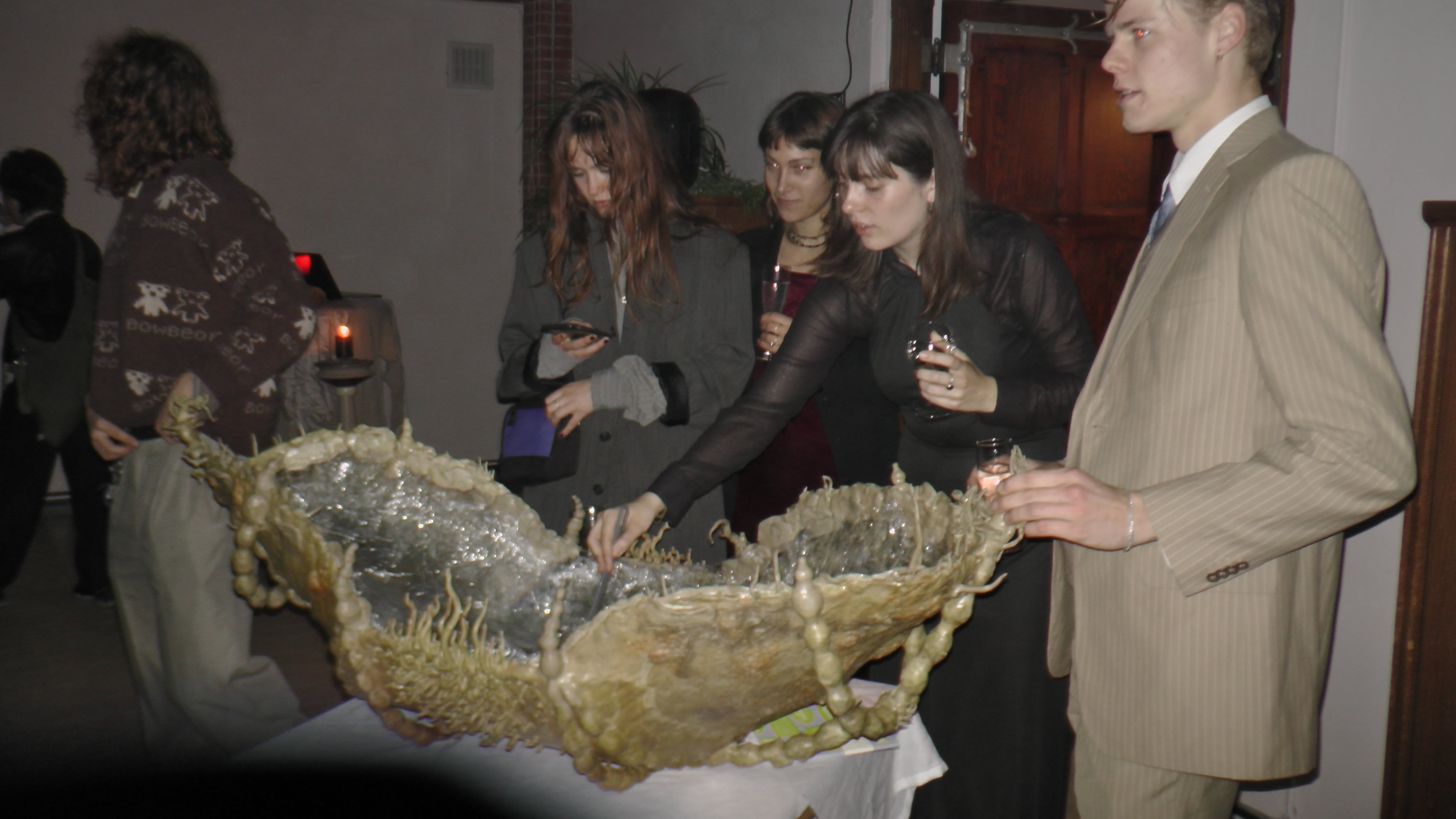 serving welcome drink from "Epibiosis (living on top of/living underneath)"