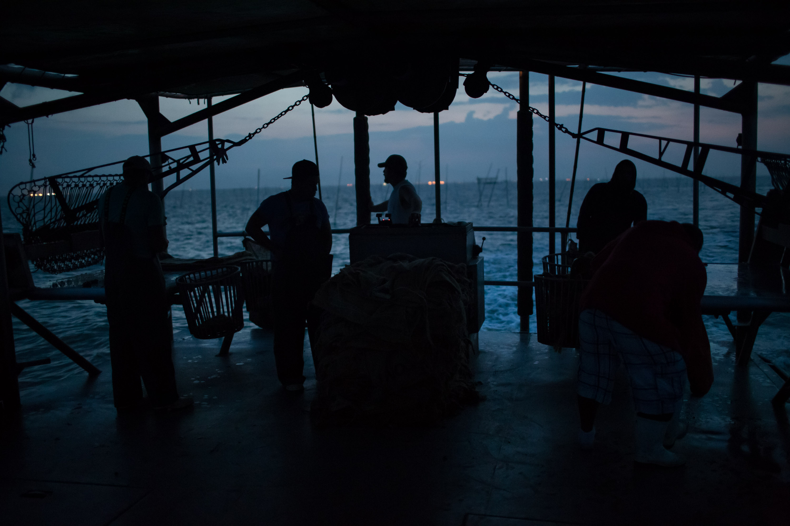 Nathan Jurisich pilots his oyster boat out into Barataria Bay, La. in the early morning.