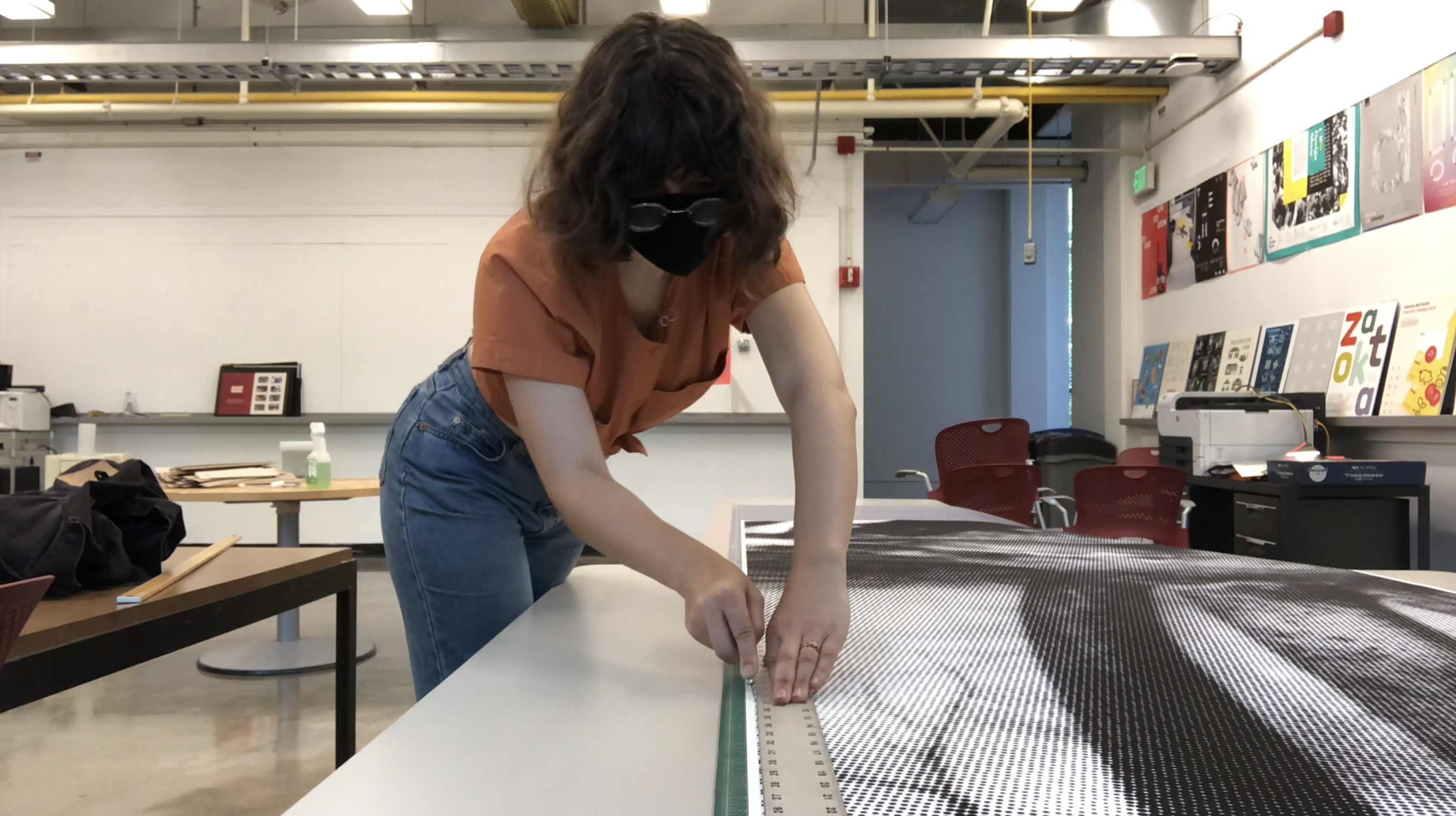 Hand trimming of exhibit banners.