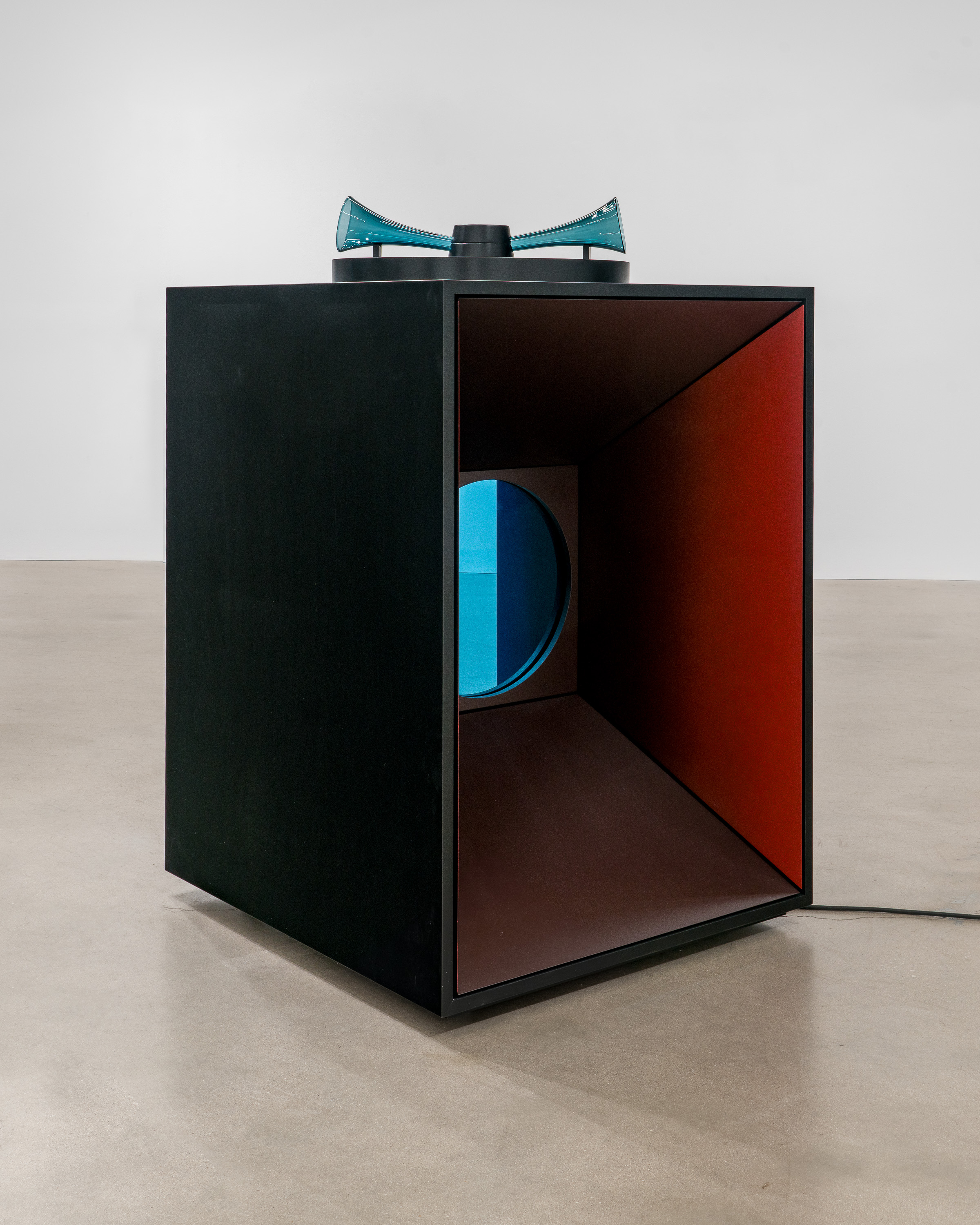 Revolving Spectral Harmonies  2023 Acrylic paint, wood, hand blown glass acoustic horns, blue industrial sheet glass, transducers, compression driver, motor and turntable assembly, audio player, metal hardware, electrical cable and plug, sound composition by David Grubbs, 60 x 40 x 37 inches.