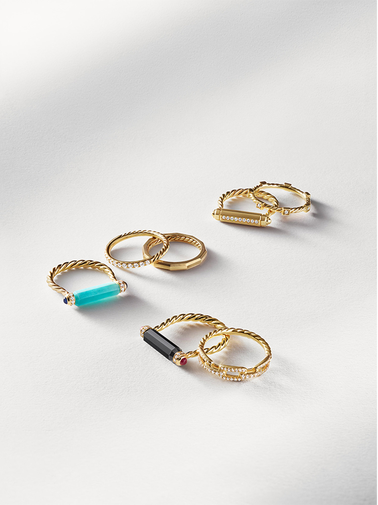 KMA stylist Sara Wacksman designs set for a photo of gold rings with blue gems with a white background for David Yurman