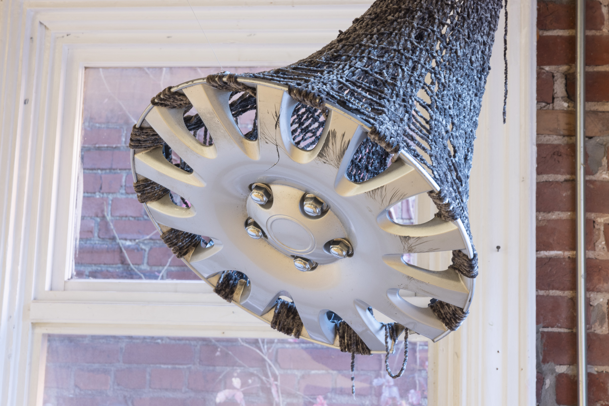 Harbinger | Found hubcap, acrylic yarn | 17 x 17 x 29 in | 2024