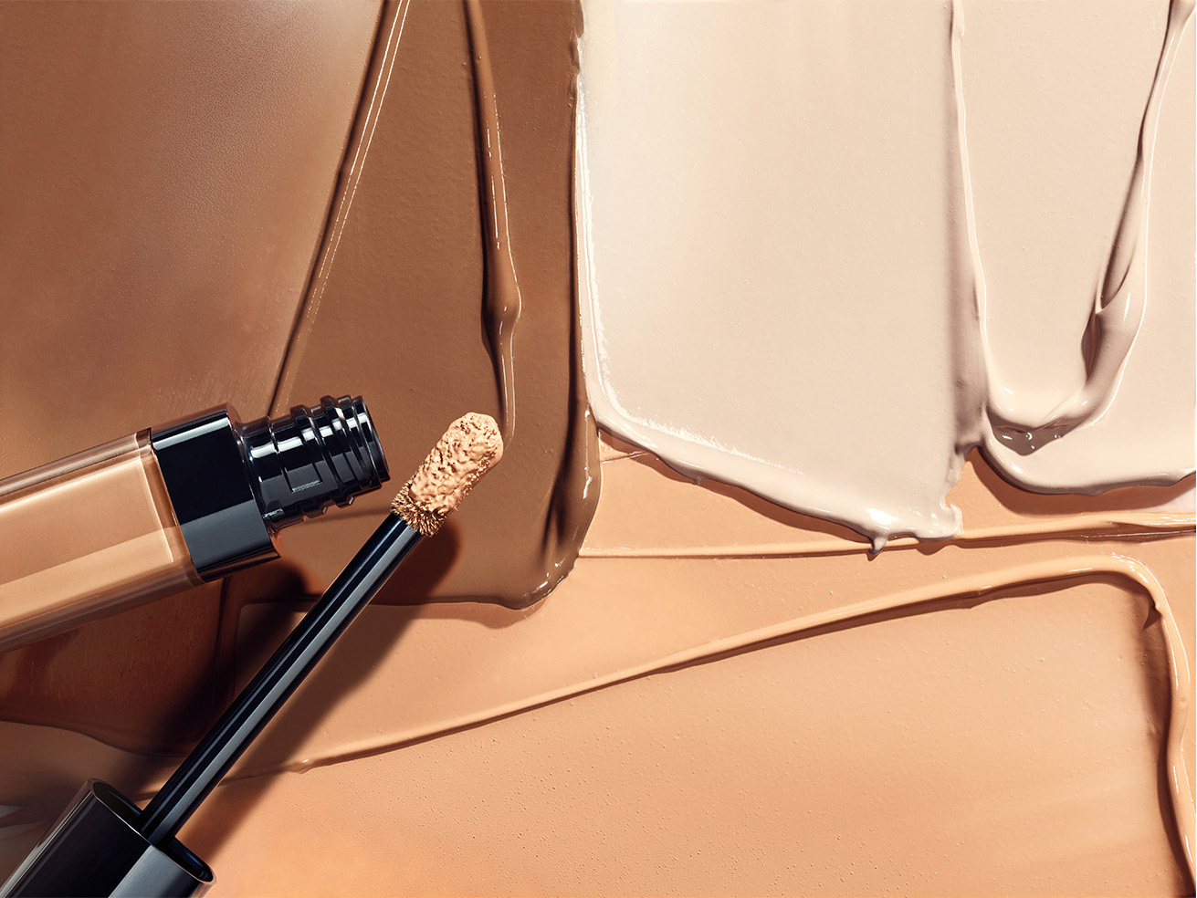 KMA stylist Sara Wacksman designs set for texture photo of many Bobbi Brown foundation shades smeared on a tan background