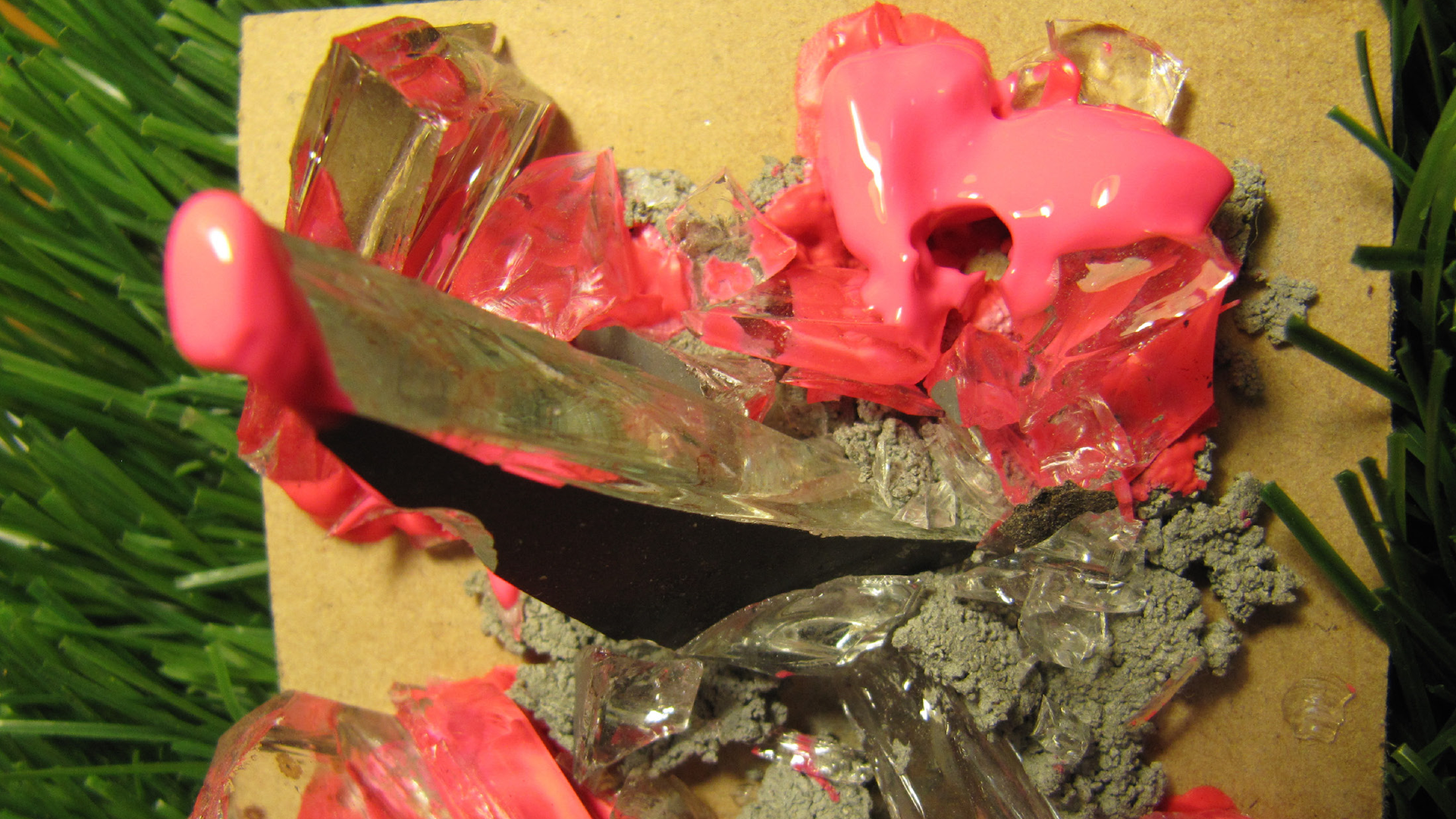 Mixed media collage of 3D textures including silver foil, plastic, concrete and glossy pink paint.