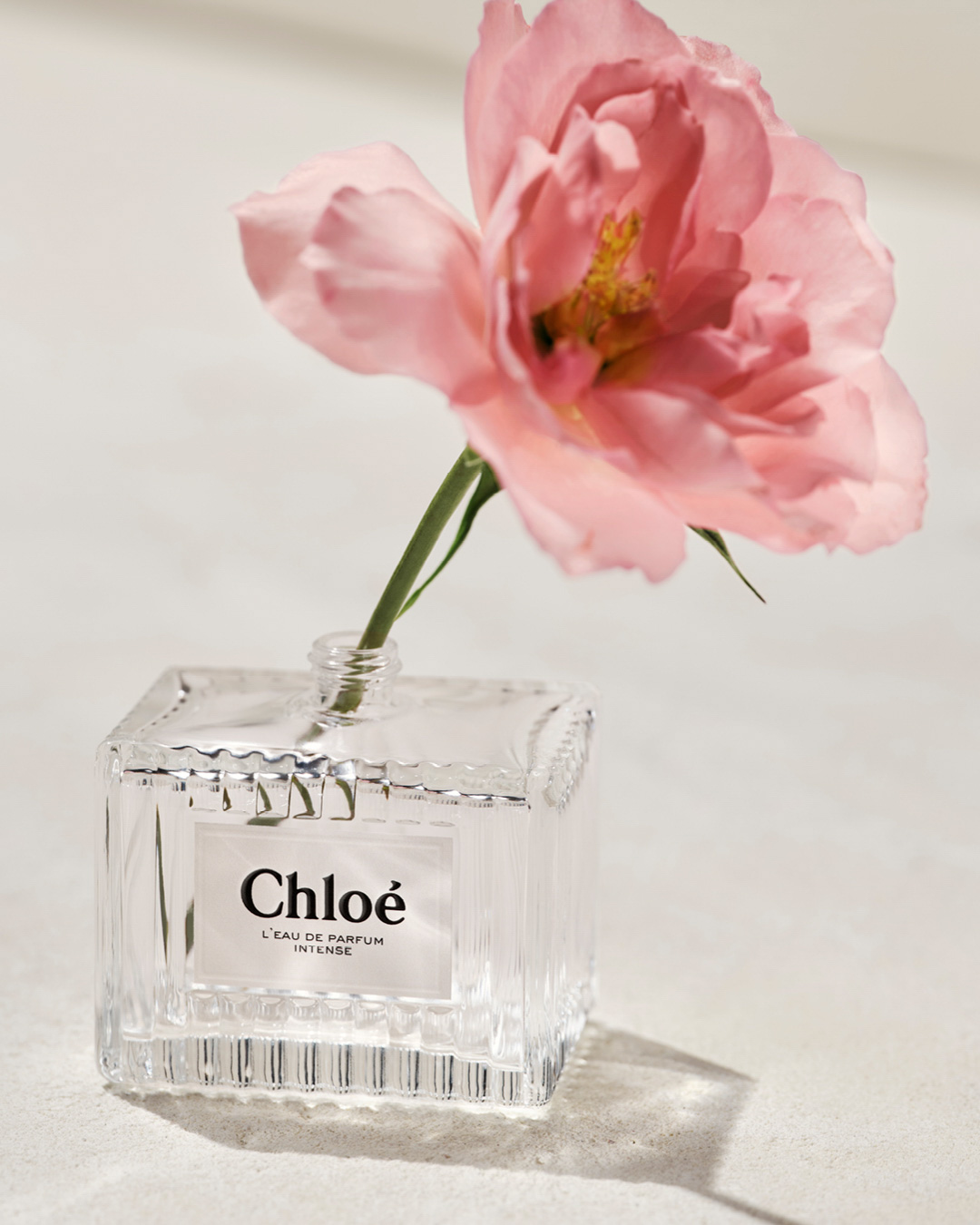 KMA photographer Vincent Gapaillard photographs a rose gold Chloe perfume bottle hanging from a string