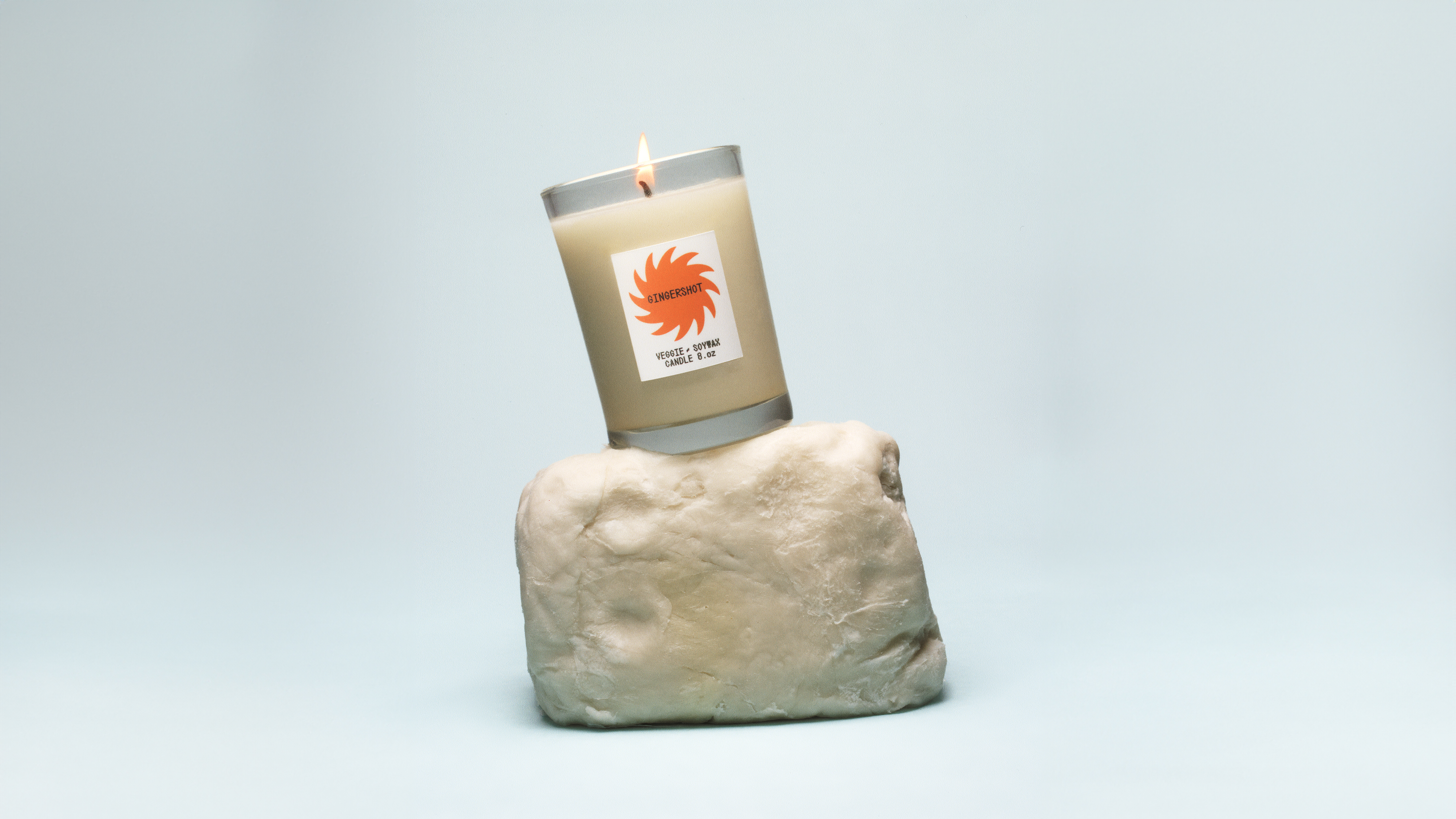 A candle on a white piece of wax