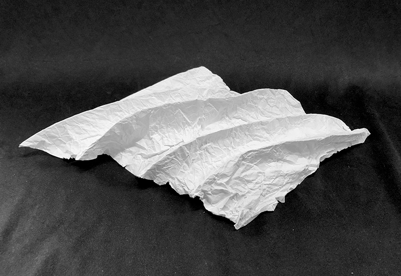 White graphine oxide sheet folded in a wave like structure.