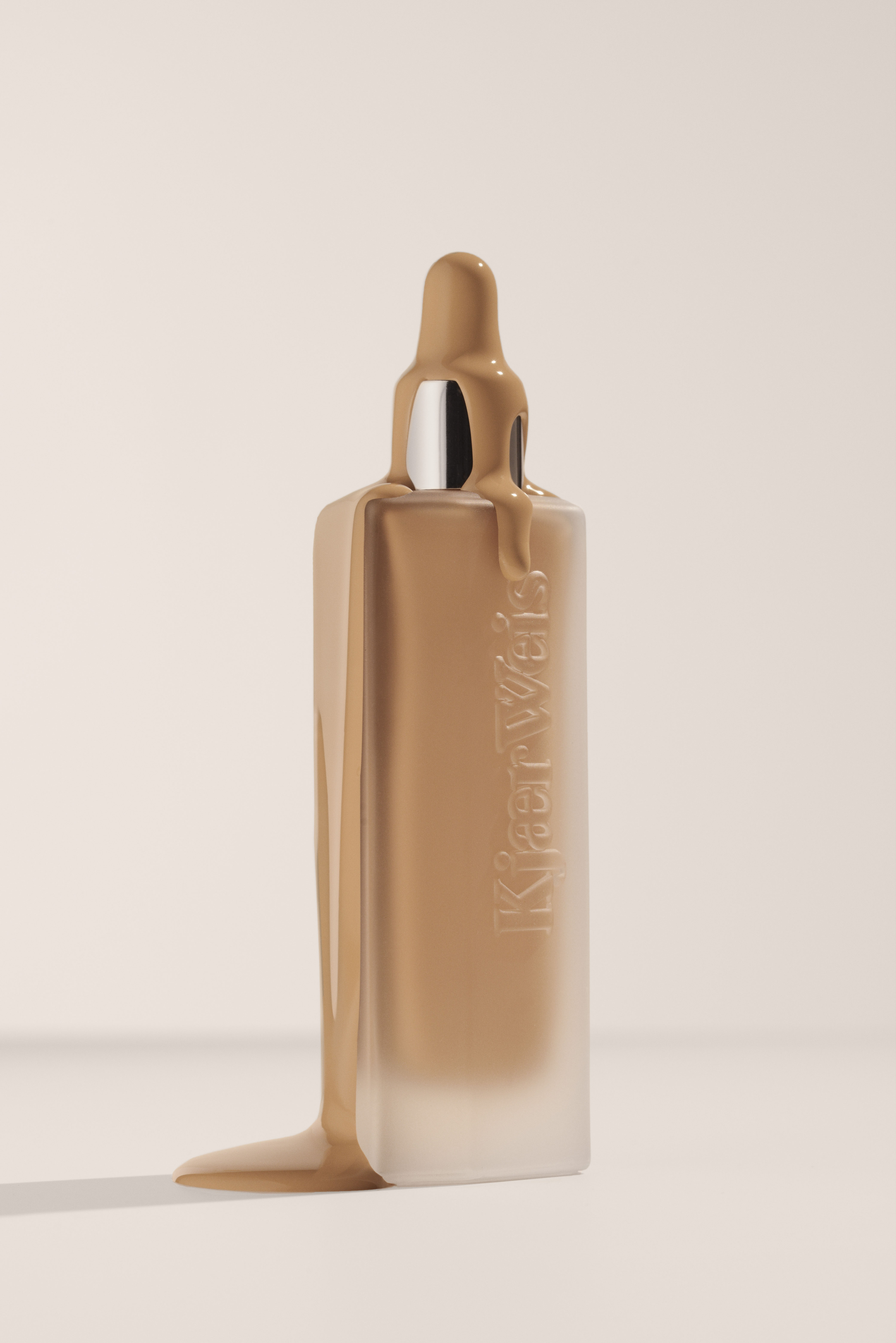 KMA stylist Sara Wacksman designs set for photo of clear bottle with foundation dripping over the side for Kjaer Weis