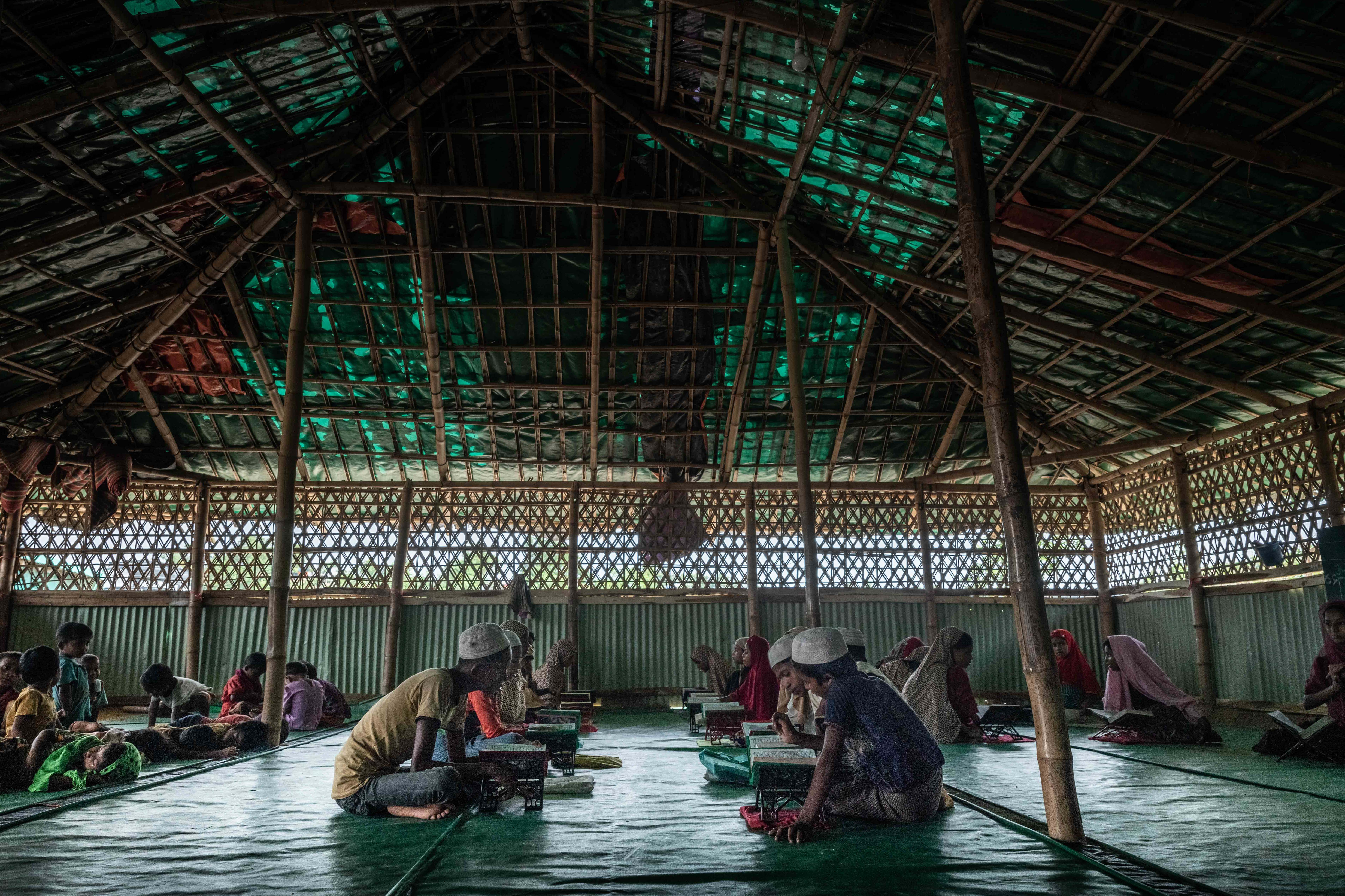 Rohingya children recite the Quran at one of Balukhali refugee camp’s many makeshift mosques in Cox’s Bazar, Bangladesh on August 8, 2018. With no formal schools in the camps, the only education many Rohingya children receive are from temporary learning centers and ‘maktabs’, religious schools teaching Arabic and Quranic education.