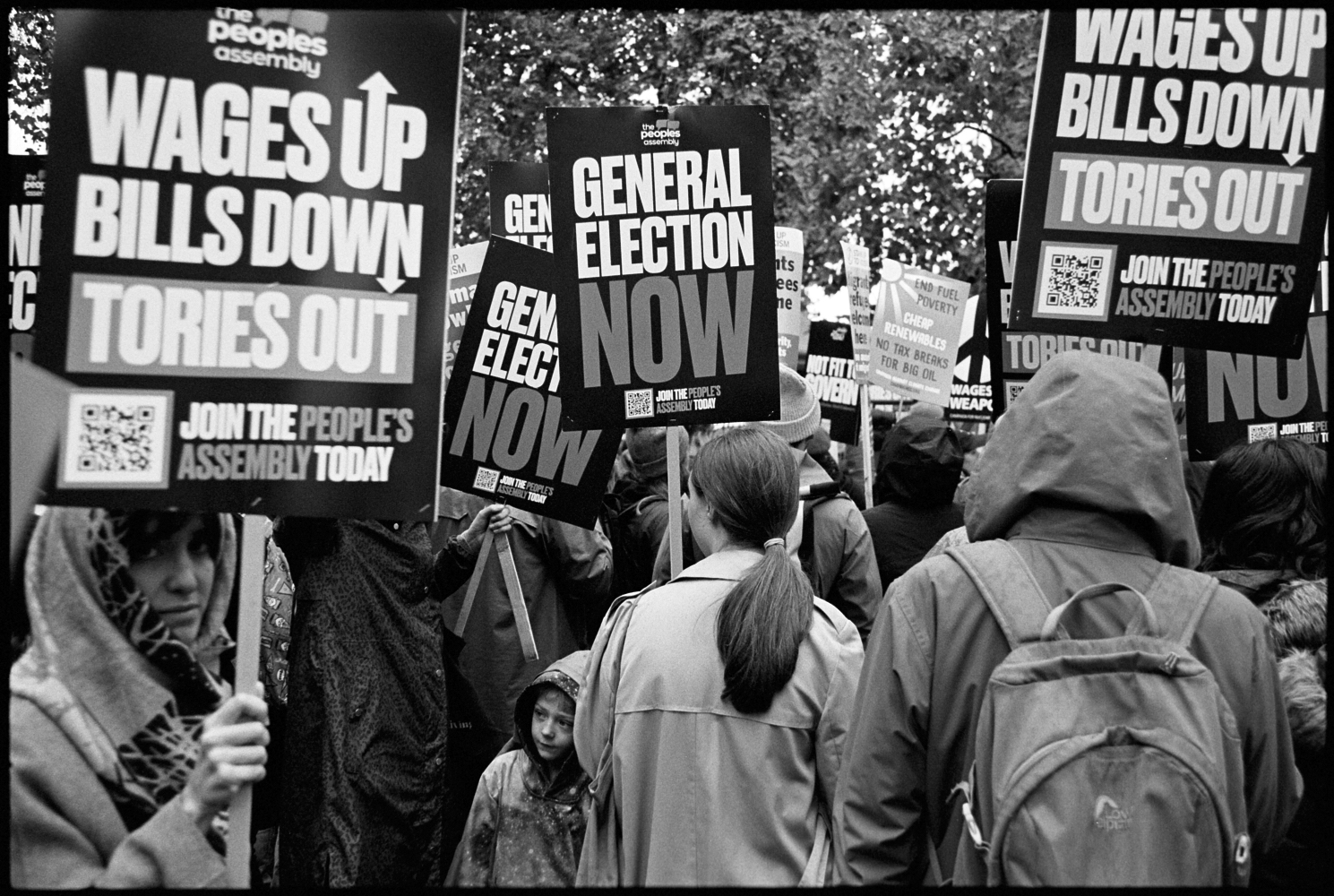 Protestors hold up placards during The Peoples Assembly march. November 2022