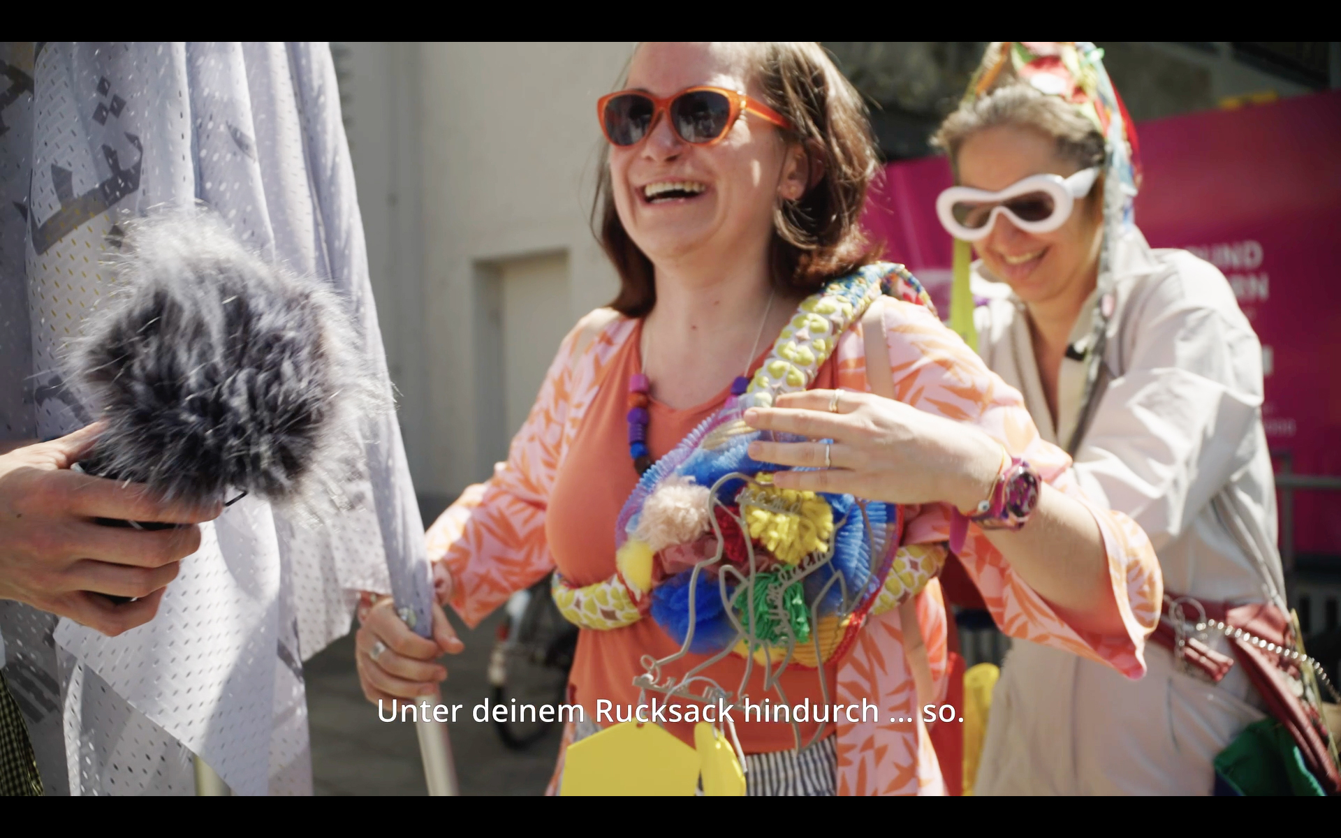 Video still. The Memory Person invites participant to carry mementos during the performance. Performer: Viviana Iacob. Giesing, 2023. Image: Mathias Reitz Zausinger.