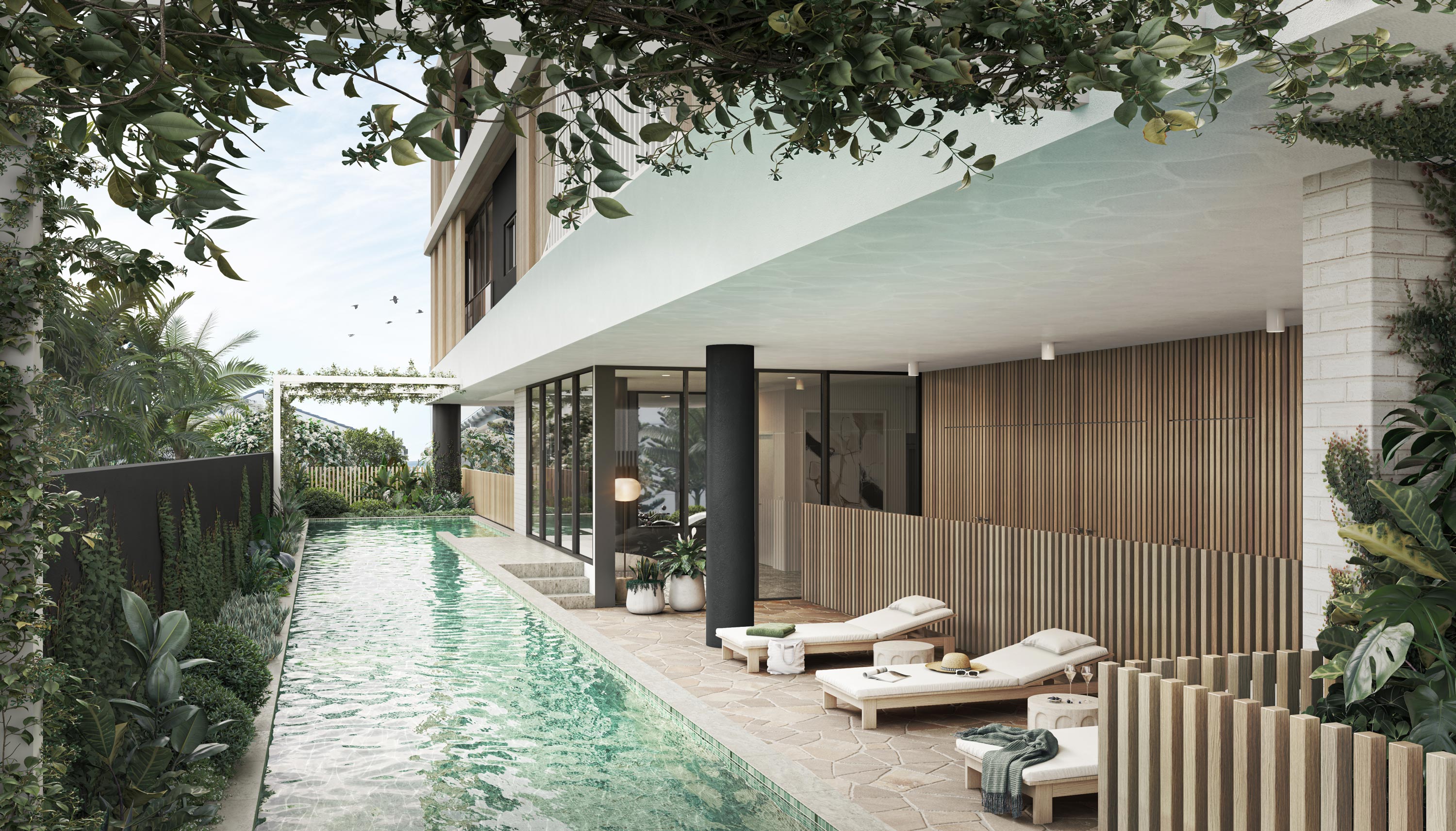 A resort-style pool with deck chairs, surrounded by lush landscaping.