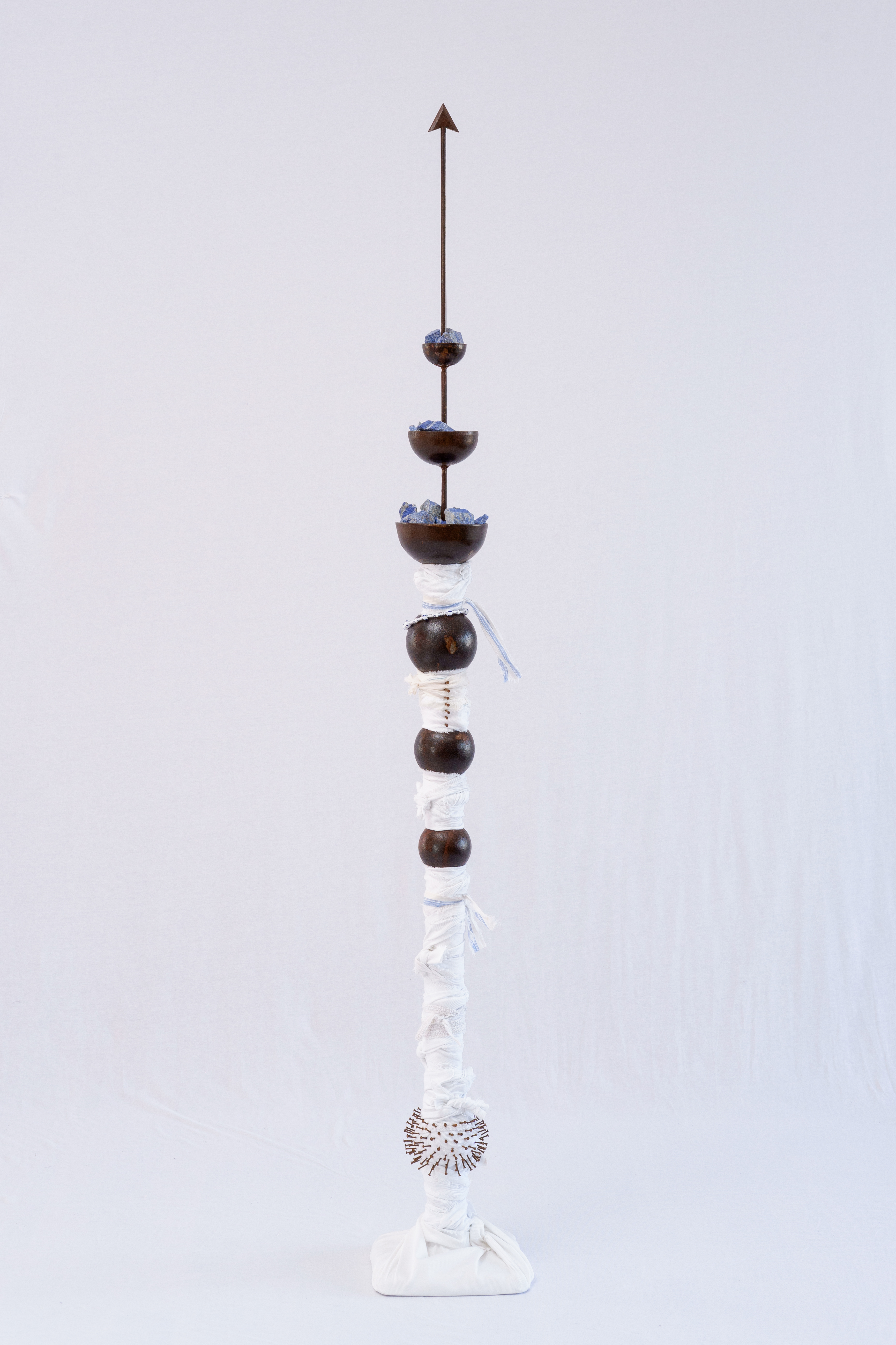 THE BEADS OF MY ROSARY ARE ARTILLERY BULLETS (7)Iron, lapis lazuli, fabric and glass. 137 x 20 x 20 cm. 2024