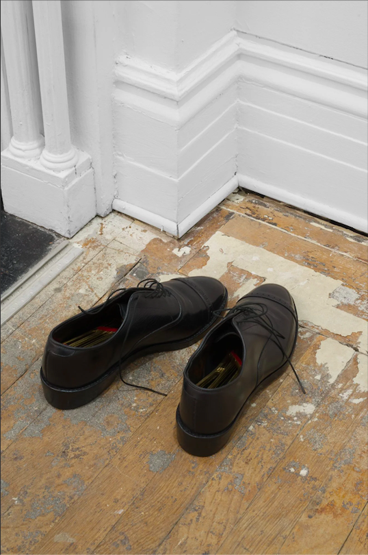 Parting Gift - Story of a dreamed object 2025; oxford uppers(found), ash wood (soles), bronze (harp), copper, felt, oil paint, shoe polish, / Book; cotton string, rice paper, pva glue, partition stand(found)