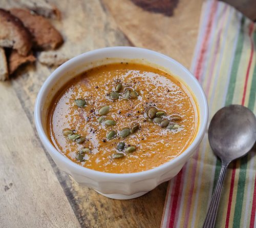 Seen from above, a delicious looking picture of a small bowl of butternut squash soup