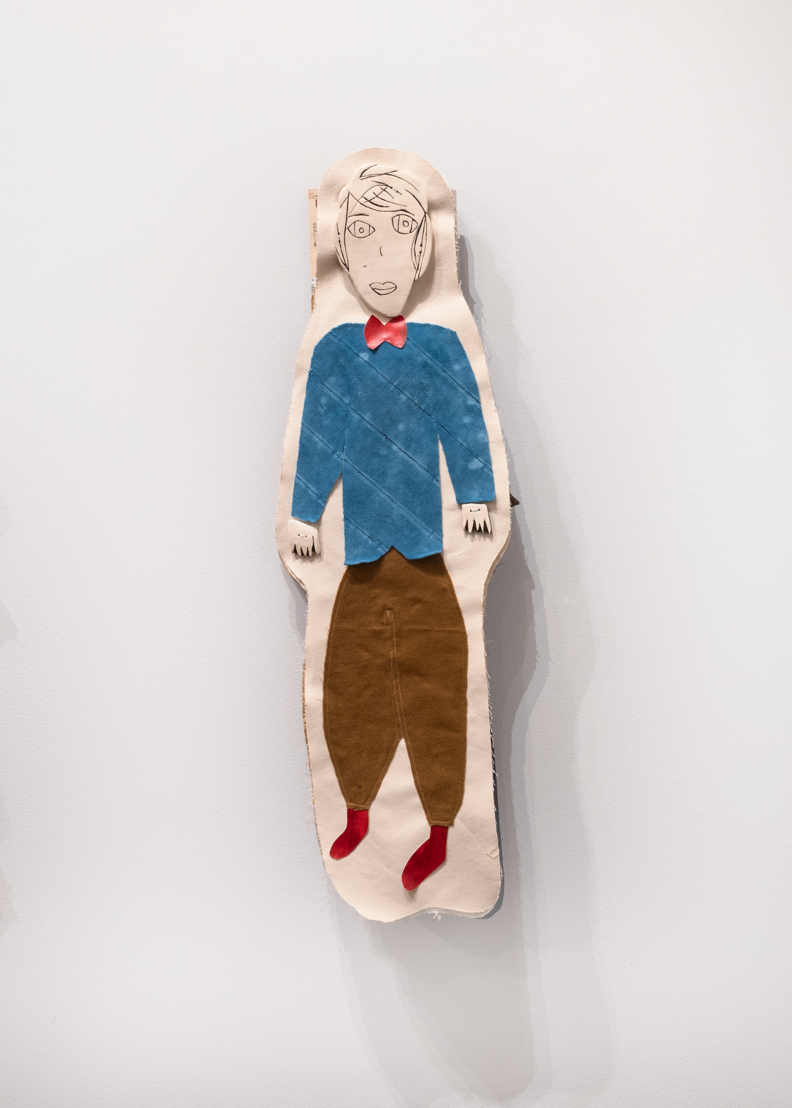 Michael 2024 ceramic, salvaged fabrics, found artworks, books and VHS tapes $850