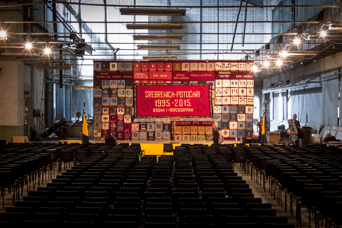 The stage prepared in the former UNPROFOR headquarters building, adorned with the Mothers of Srebrenica's handwoven handkerchieves.