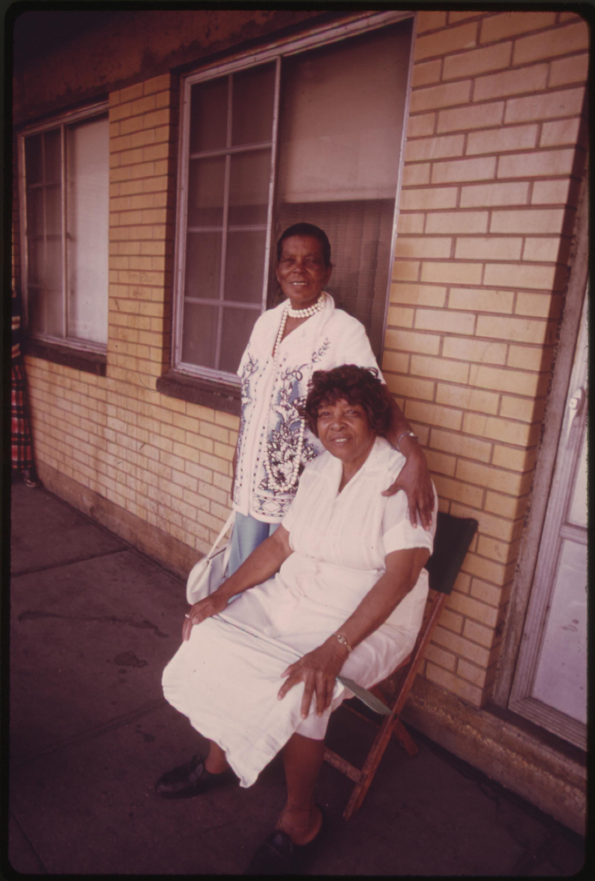 Black women on one of the balconies of the Robert Taylor Homes, low income highrise apartments in Chicago. It is a complex of 28 buildings located between the 3900 and 5400 blocks on State Street with 4,312 apartments housing 25,220 persons. Median Black income from 1960 to 1970 increased from $4,700 to $7,883 but was $3,603 below median white income. Chicago Blacks with an income of more than $7,000 during the period jumped from 26 to 58 percent, June 1973.