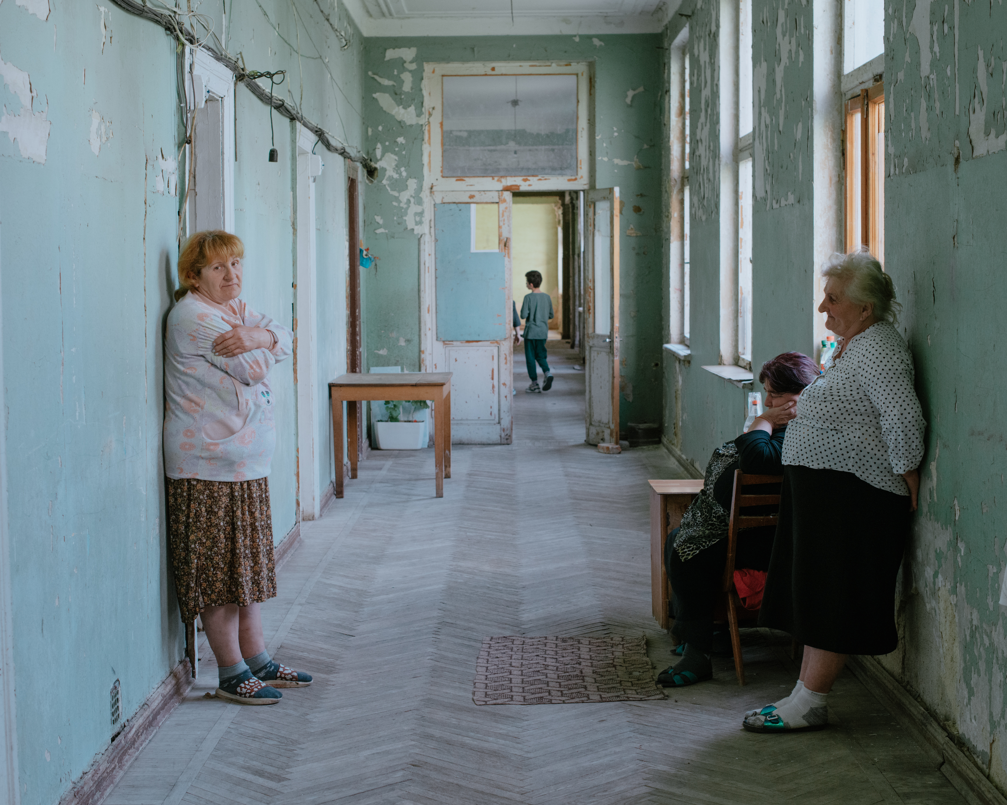 Jamse, Marina and Uligu, refugees from Abkhazia, in the corridor of an abandoned Soviet sanatorium where they have been living since their escape in 1992.