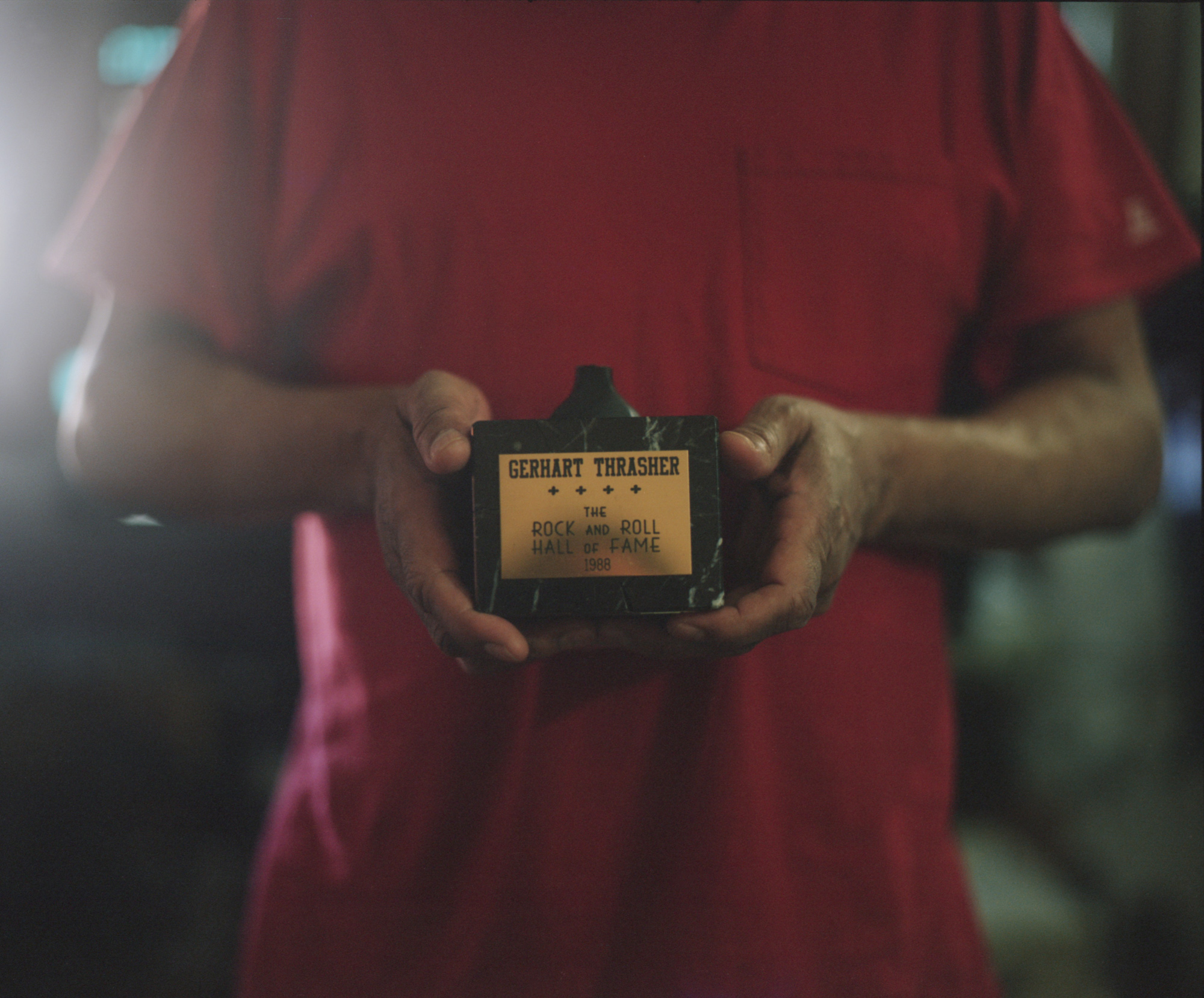 Gee, son of original band member of The Drifters, Gerhart Thrasher, holds the base of the Rock and Roll Hall of Fame trophy from his father&rsquo;s induction ceremony in 1988.