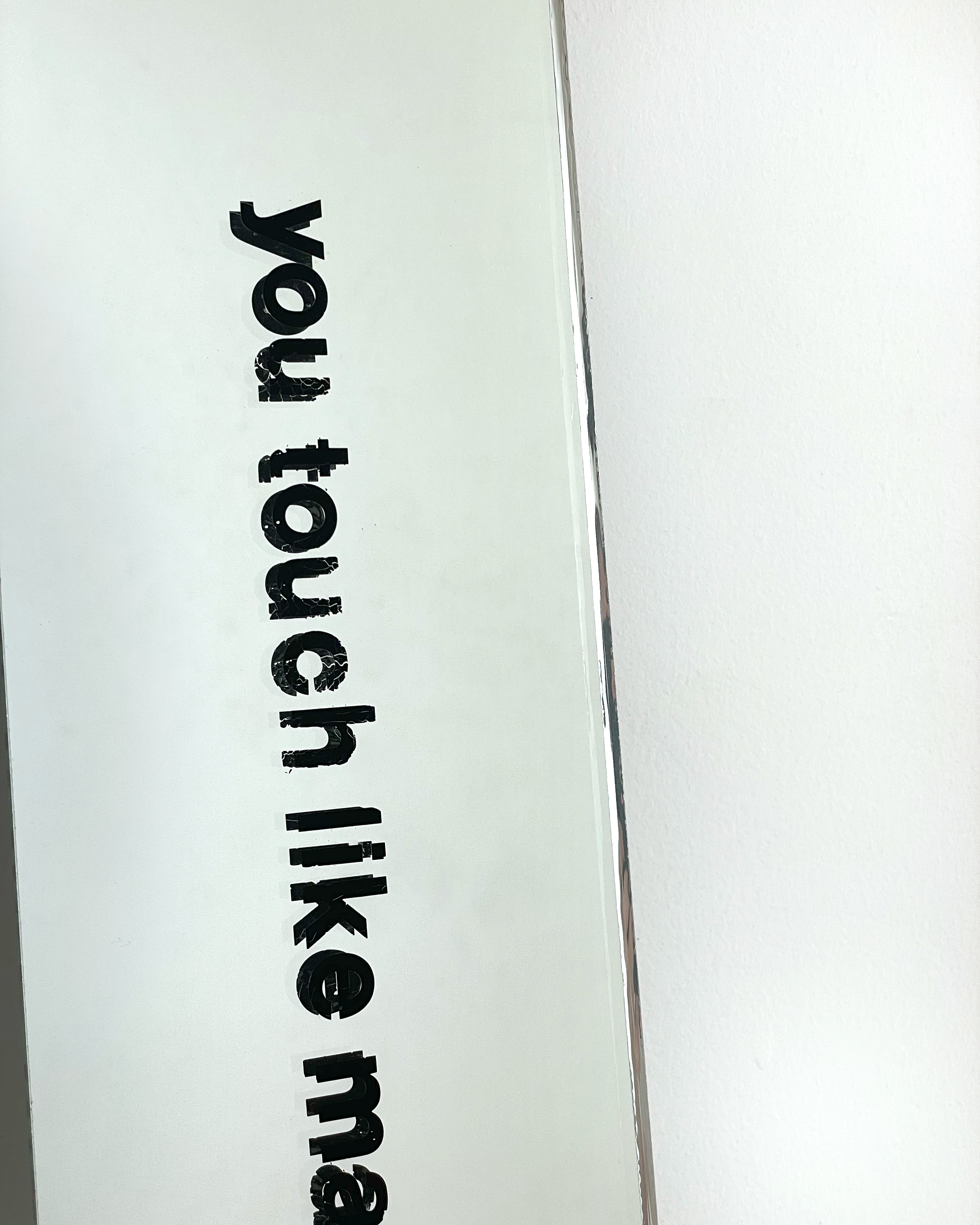 You touch like magic, dance with me now,&nbsp;2023.&nbsp; Letraset on mirror glass. 15 × 140 cm