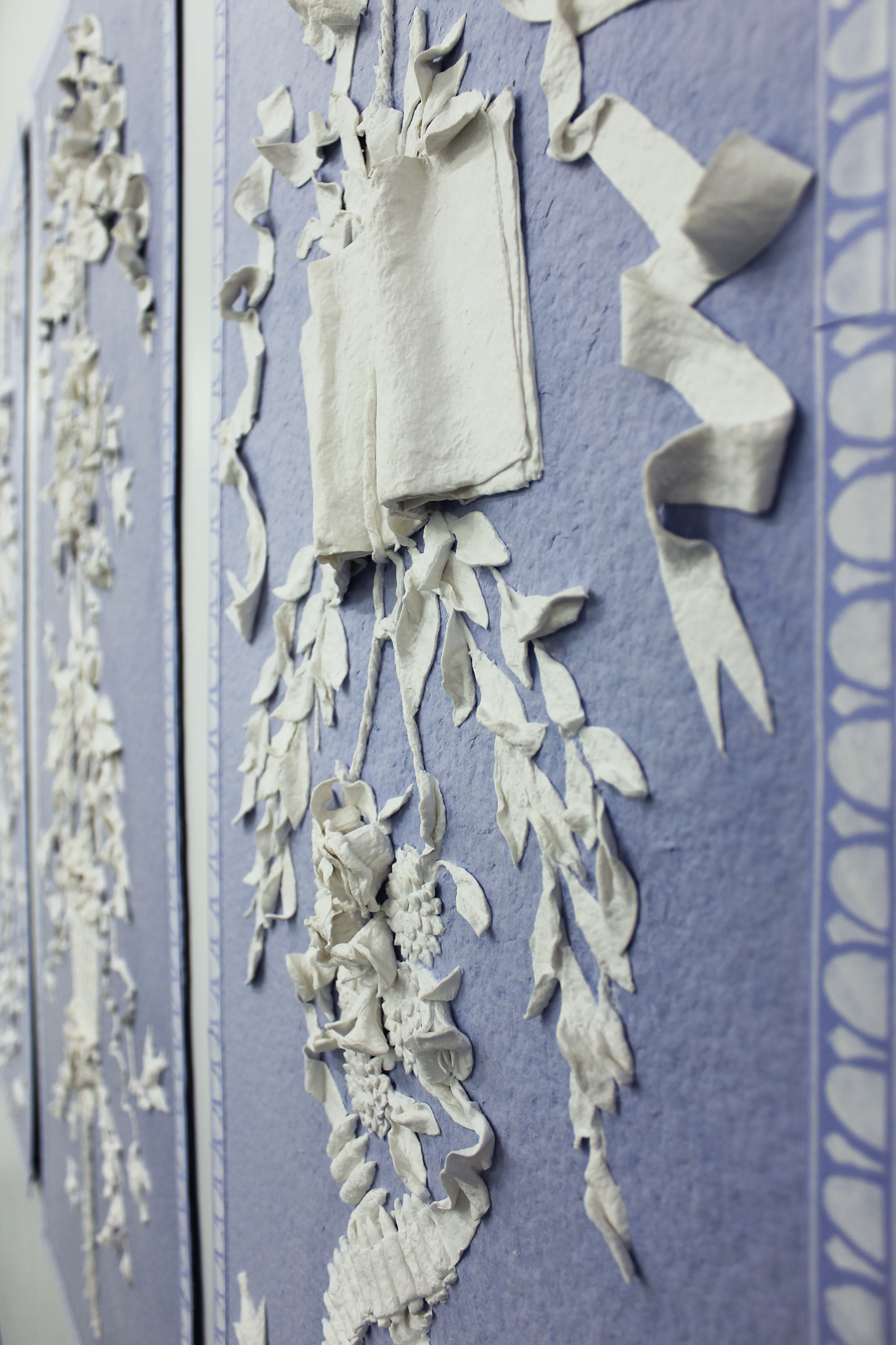 Dialectical Folly (detail), 2018, Left - 60" x 20", Center - 60" x 29", Right - 60" x 20", handmade paper, molded and stenciled borders. Courtesy of the artist.