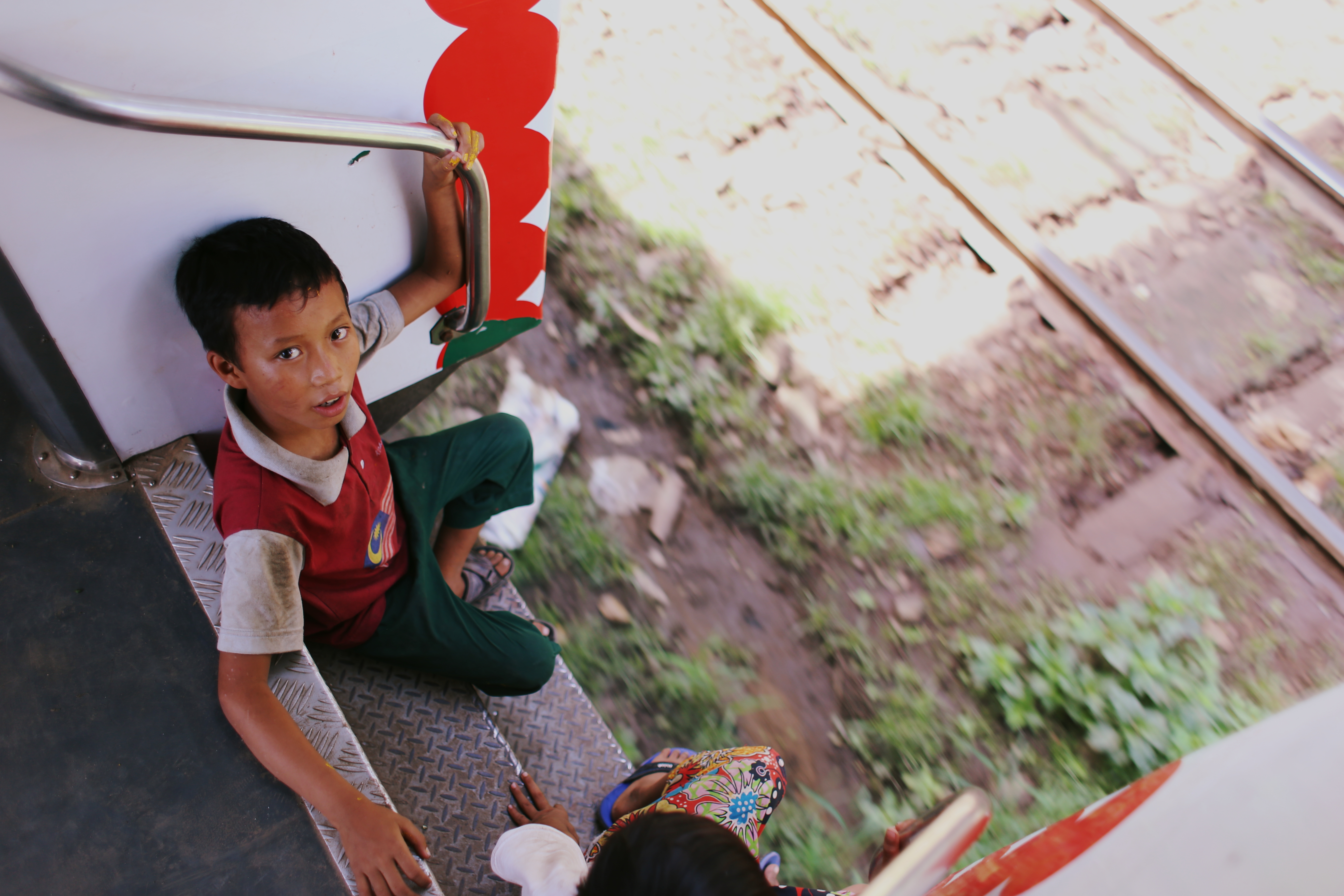 Burmese children chat loudly and fight with sticks that they snatch from the ground as the train rolls on. They play hide and seek through the rattling carriages, jumping off and greeting the local kids at each station, before sprinting back towards the train and magically reappearing on the steps as if they had never left.