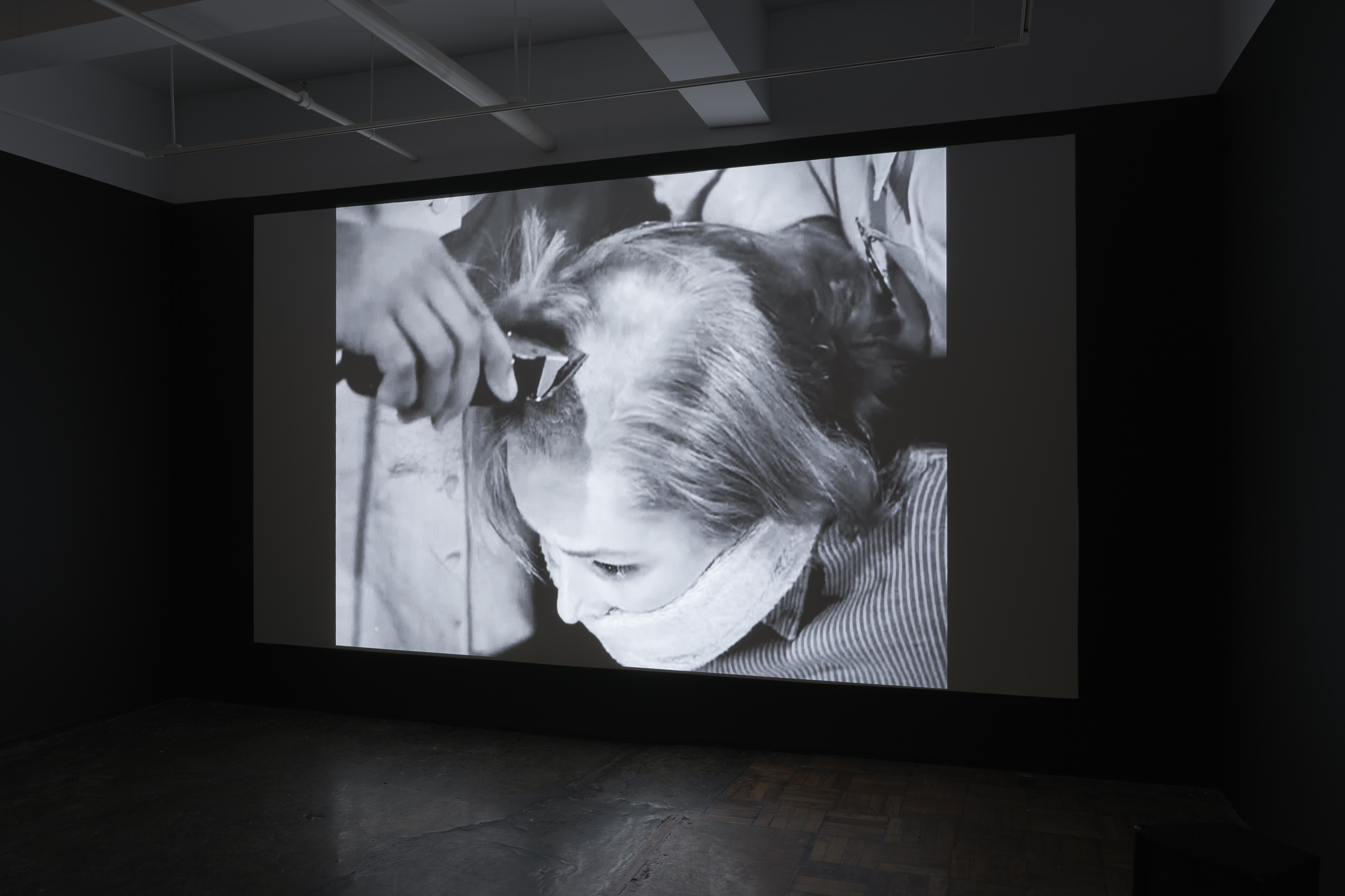 6/11 — THE HAIRCUTThe Haircut reconstructs selected scenes from movies where female characters cut their hair or have their haircut unwillingly. Reasons range from pretending to be a man to compete in a horse race (National Velvet, 1944), embodying a feline aesthetic as a vigilant antiheroine (Catwoman, 2004), aligning with male military standards (GI Jane, 1997), to retaliation by classmates for being involved in a severe cyber-bullying case (We Not Naughty, 2012).The provided file hosts a ten-minute excerpt from the project. The full-scale work contains close to 600 scenes with an approximate duration of 18 hours, to be presented as a single-channel video installation.Video, 18 hours, 2018-2020. Installation images at AIR gallery by Sebastian Bach