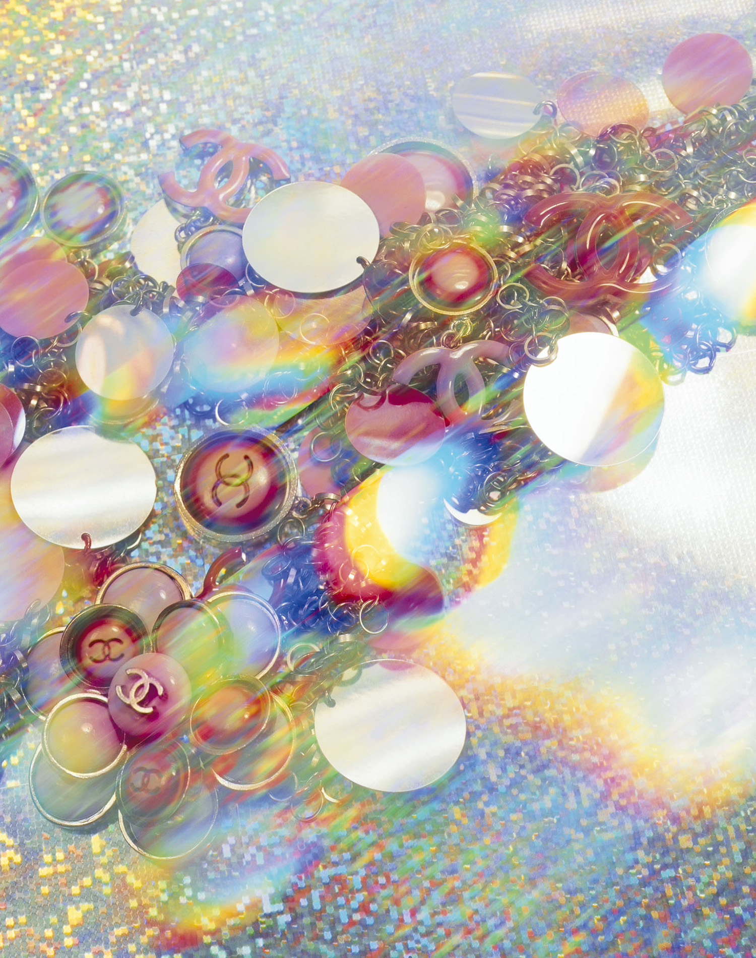 KMA photographer Daniel Schweizer shoots a photo of colorful necklace pendants against a rainbow background for Chanel