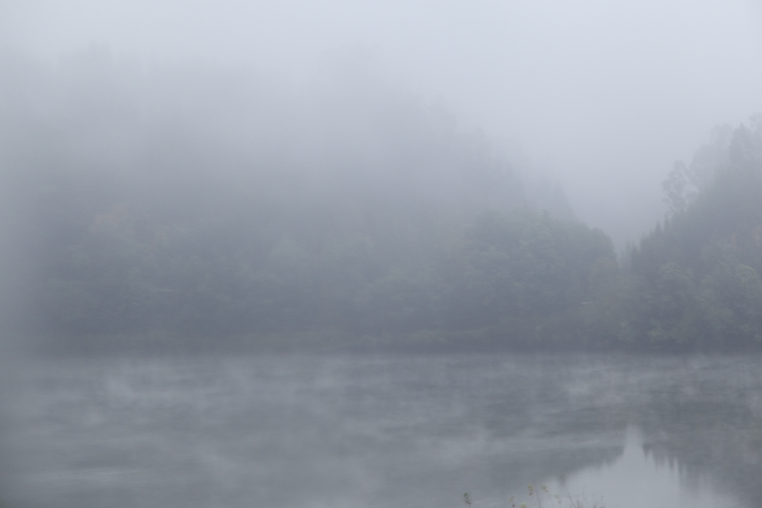 carina martins, time passing through montain - foggy lagoon with blue and grey tones 