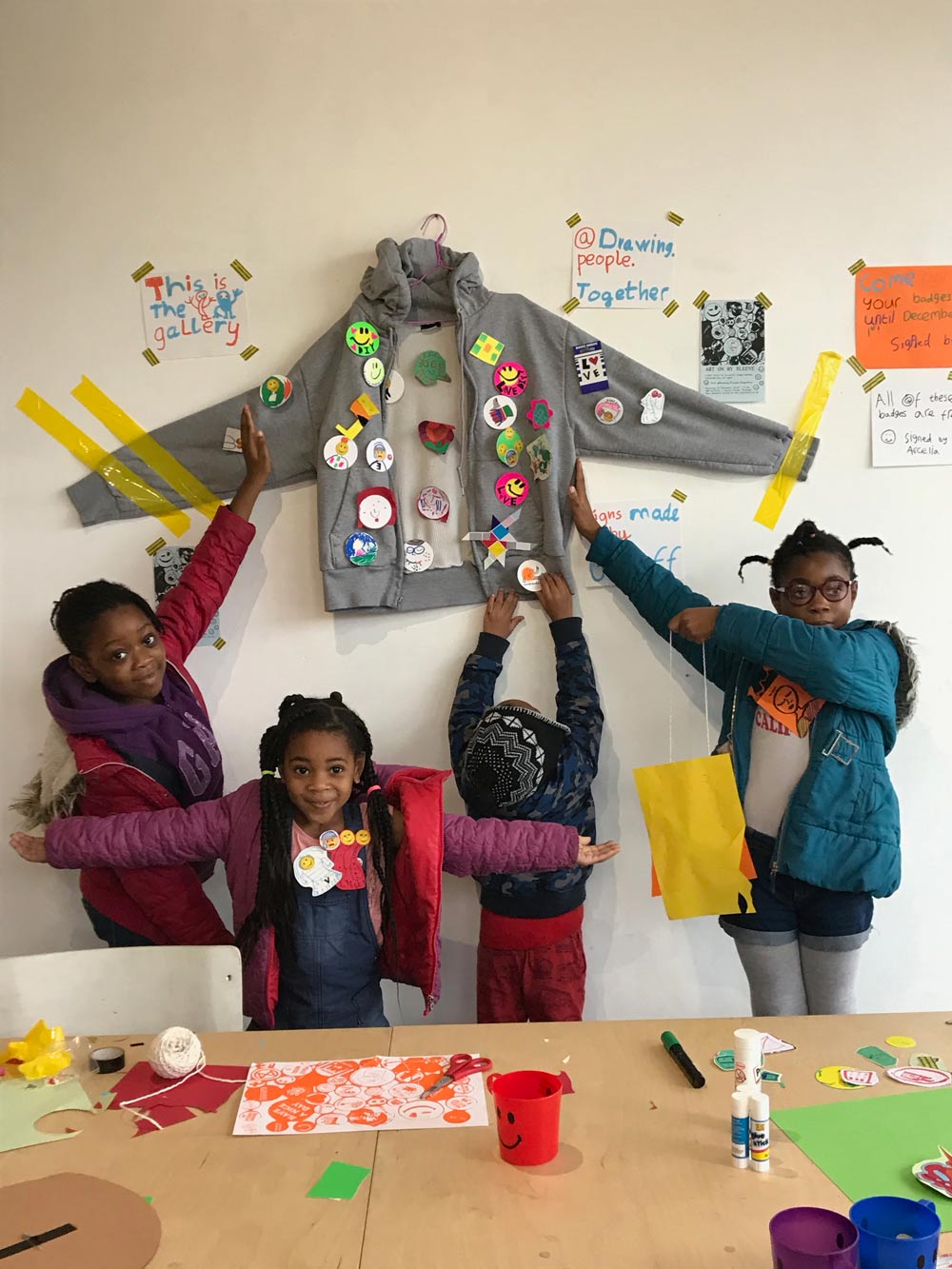 Badge makers displaying their work at 'Art on my Sleeve' a workshop by Drawing People Together.