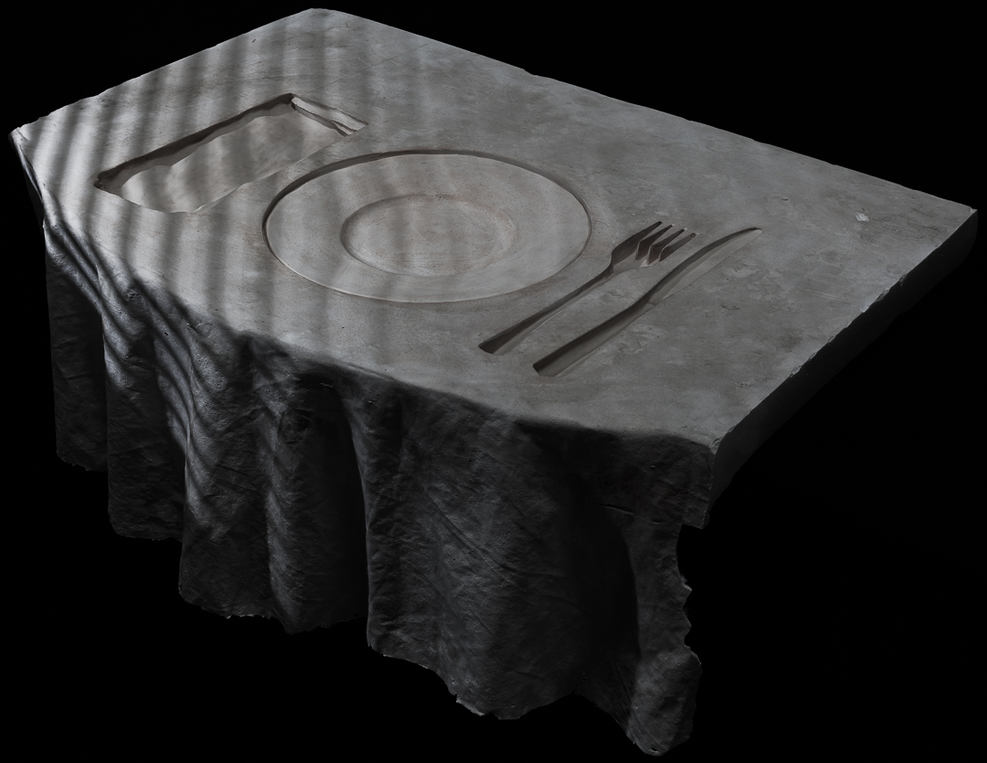 a segment cut out of a table with a place setting depressed into it