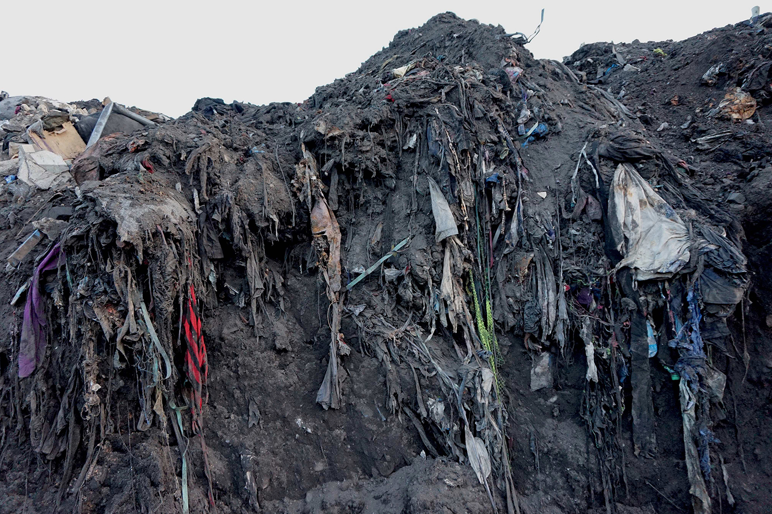 Trashed clothing doesn’t retain its shape when it is thrown into a landfill or buried in the sand  Clothing gets smooshed, twisted, stomped on and it changes color as the fibers absorb whatever is around it, Accra, 10.07.2018