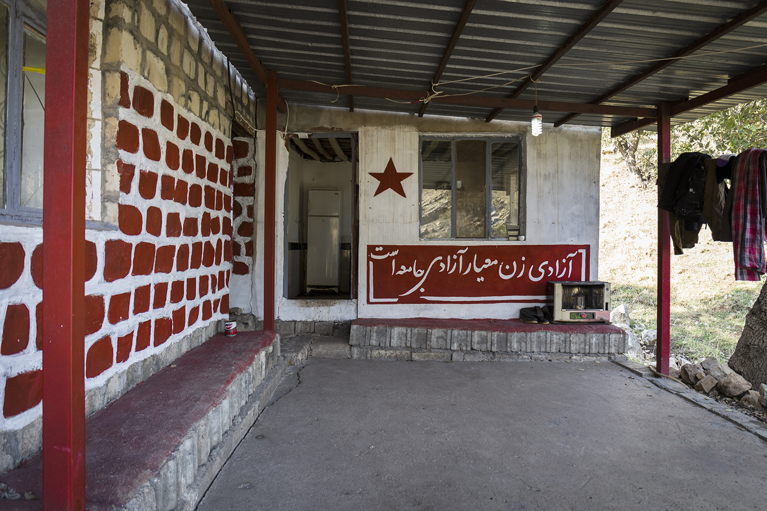 Airin Bahmani: from the series Equal on the Mountains, 2018. “The degree of freedom of a society is reflected in the degree of freedom of women.” A Persian slogan on the exterior wall of a building.