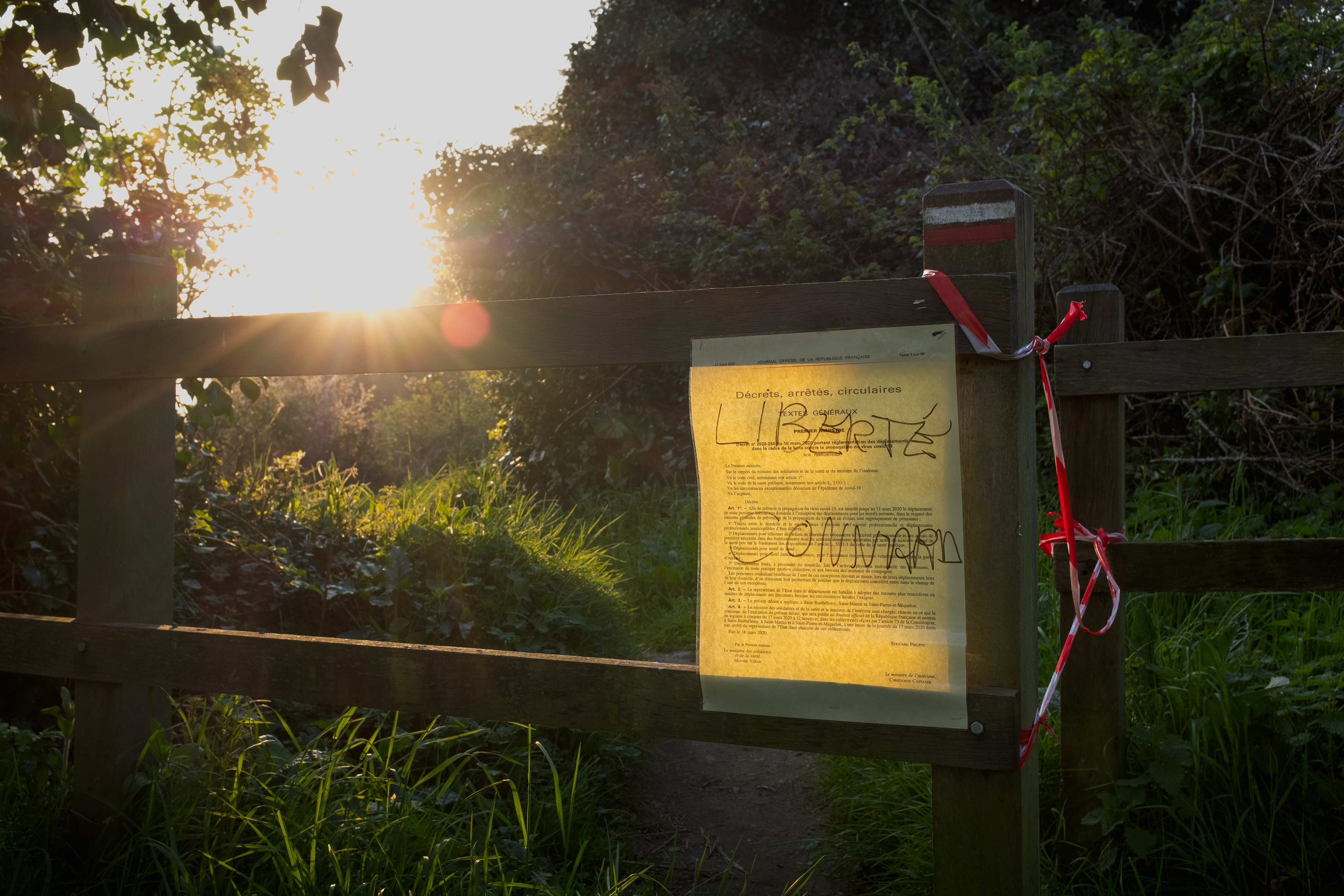 Someone tagged "Liberty asshole" on the lockdown administrative decree barring access to the coastal path.