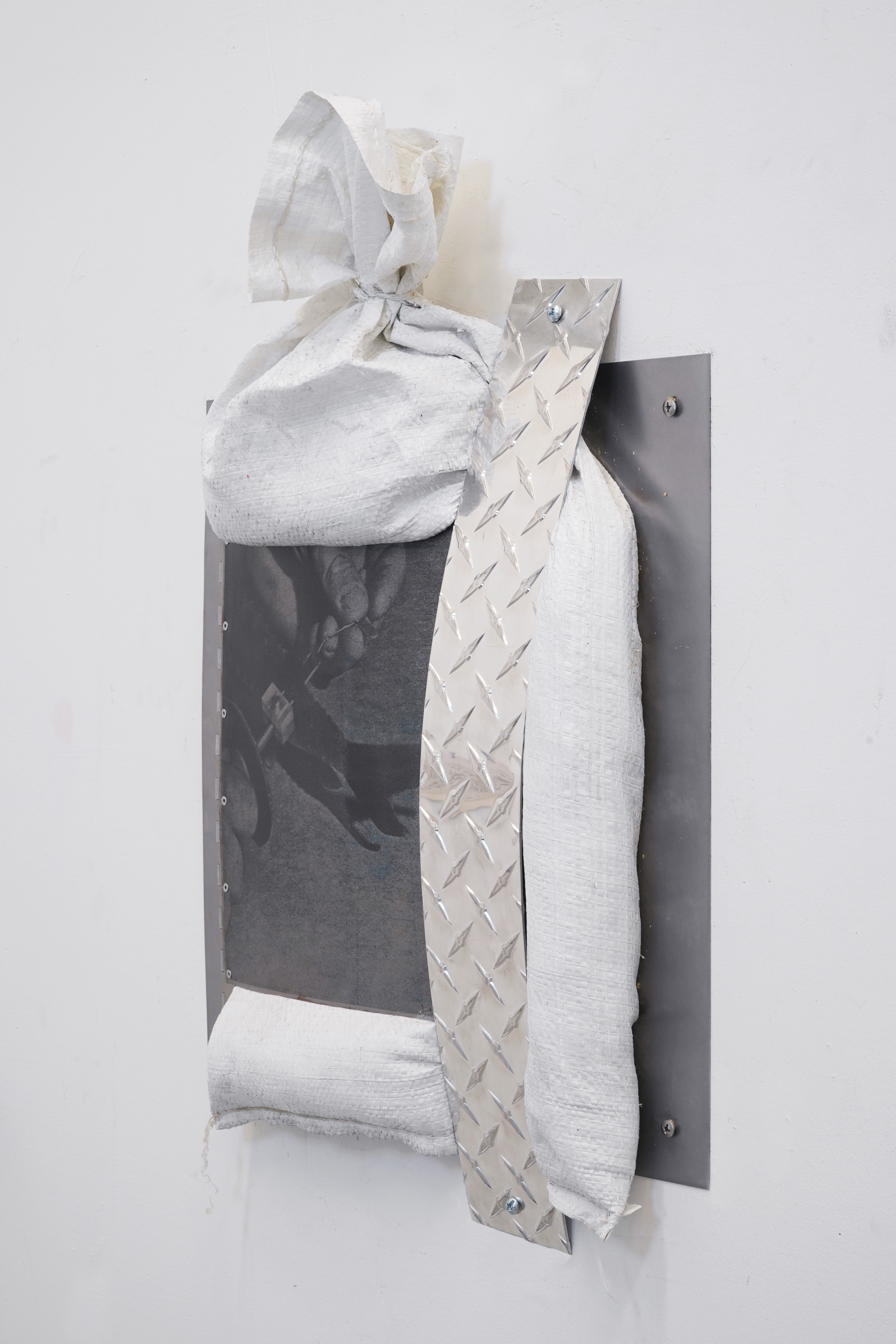 Is A River Alive?/ 2025 / Screenprint on steel, aluminum diamond plate, steel, sandbag, sand and hardware / 30 x 24 x 6 inches