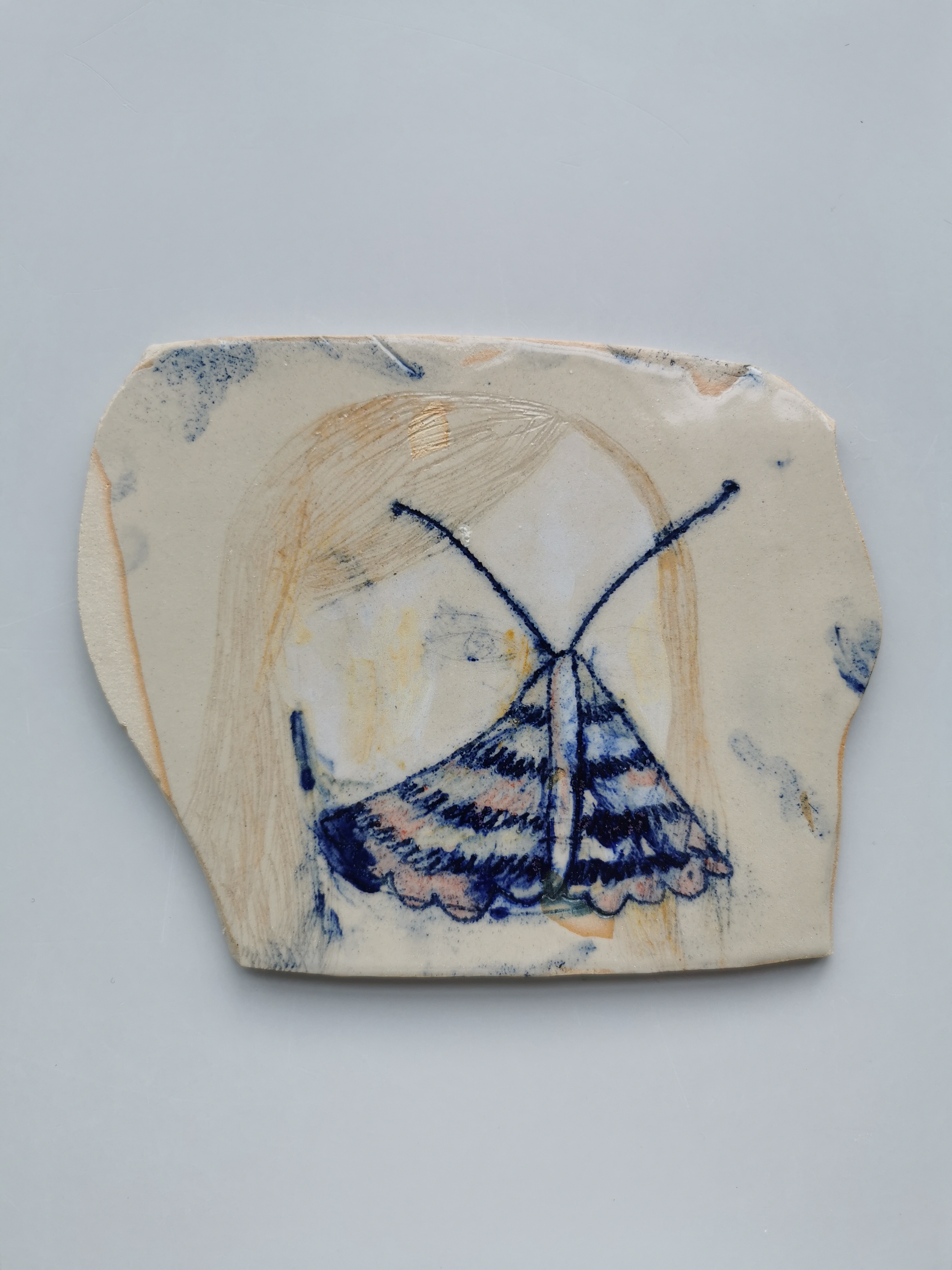 Carved, painted and glazed ceramic plates