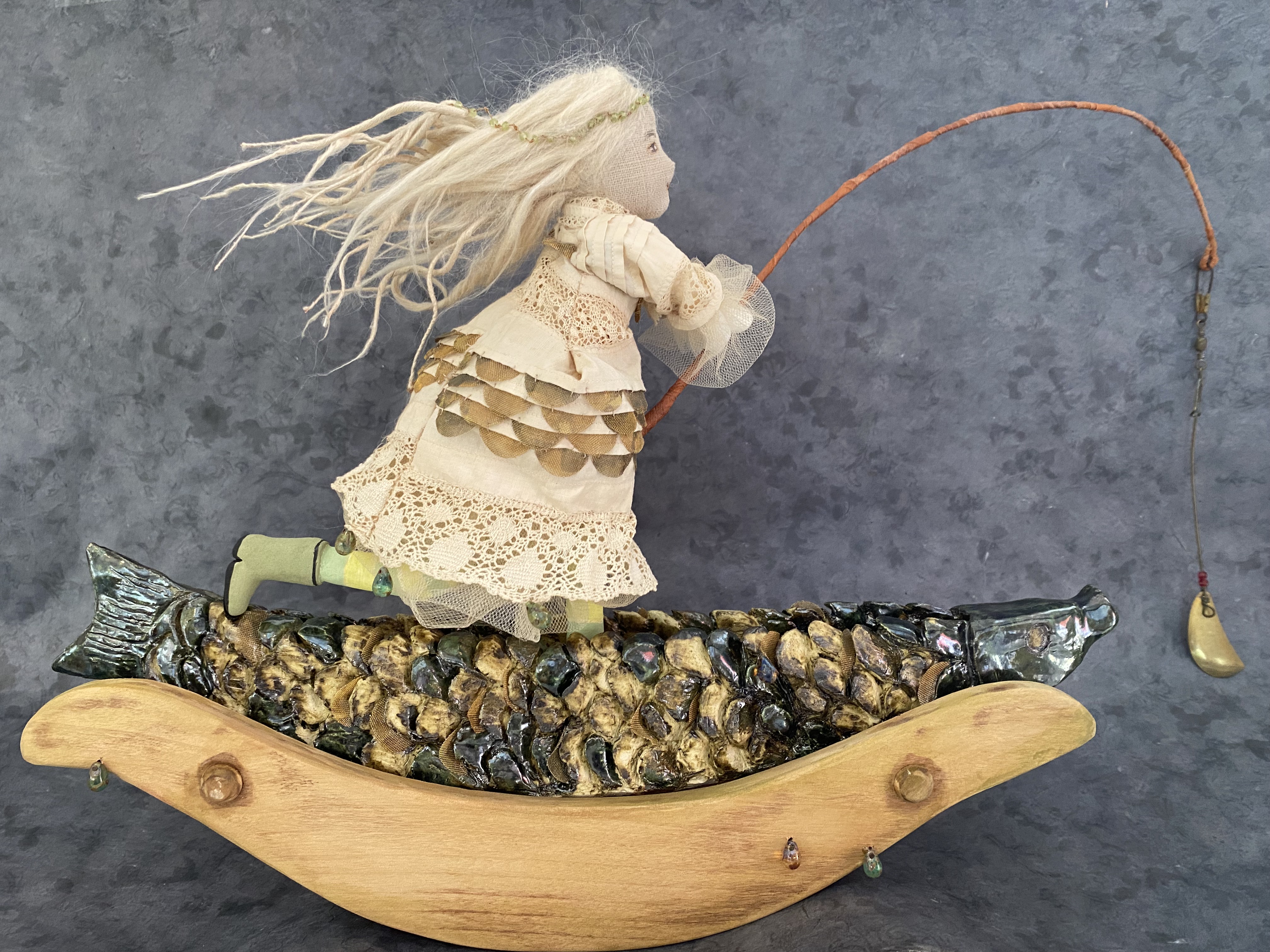 Gone Fishing → ceramic, wooden rocker painted with water colors, vintage fabric and lace, silk roving, copper screen, peridot and glass beads, wire, and beeswax