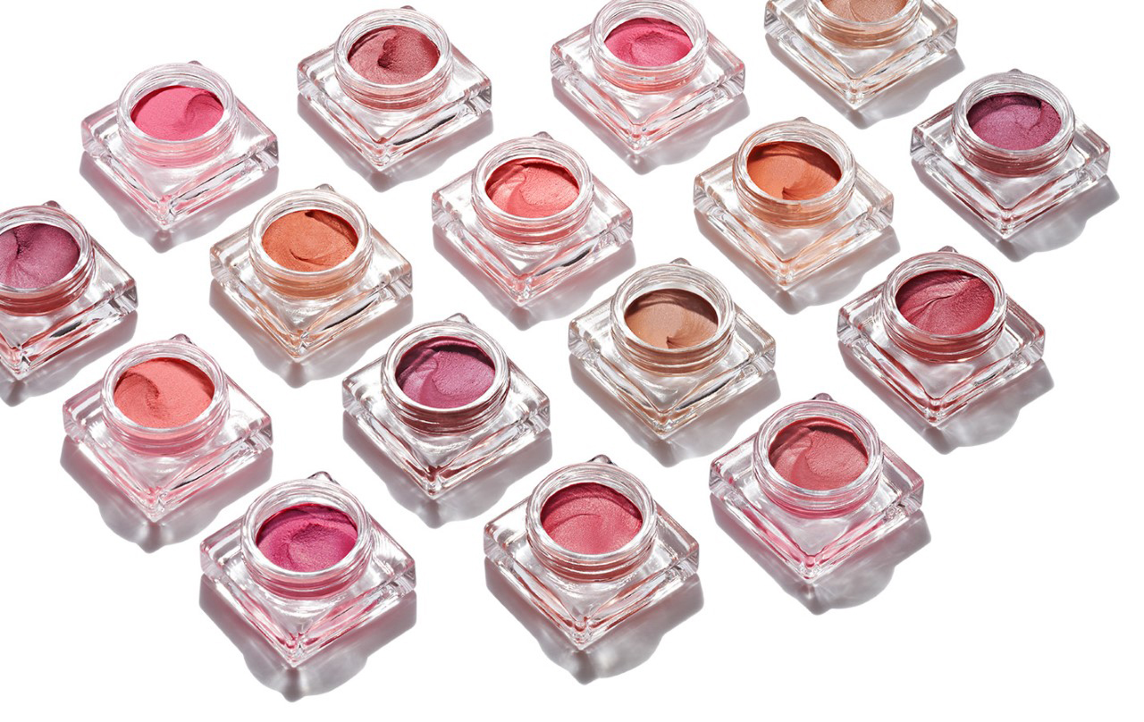 KMA stylist Rachel Haas designs set for photo of colorful lipglosses in their bottles on white background for Shiseido 
